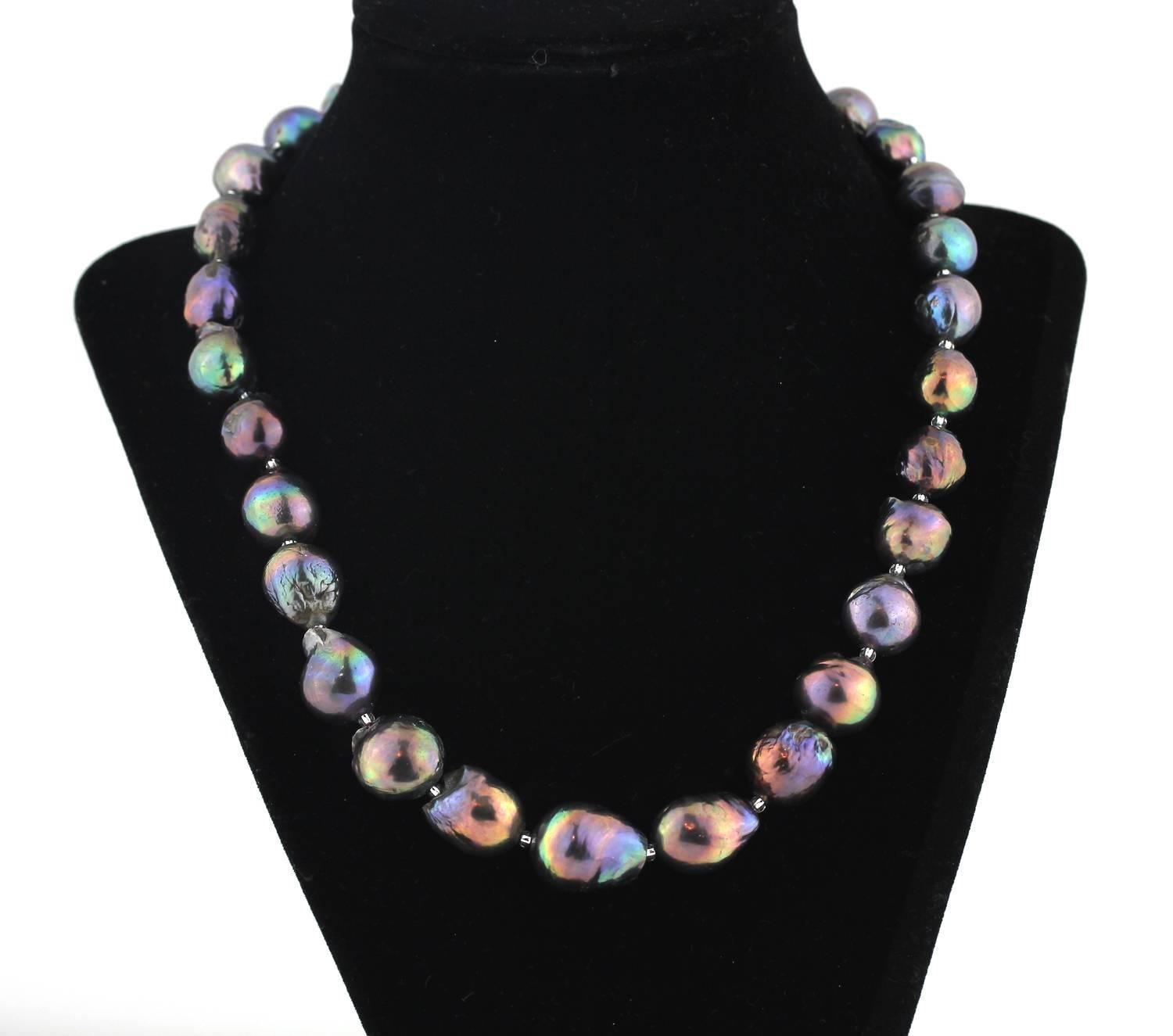 These  beautiful "beauty marked' cultured Fireball Pearls glisten and glow all the colors of the rainbow and then some !!
Size:  slightly graduated largest approximately 15 mm
Length:  19 inches
Clasp: Sterling Silver