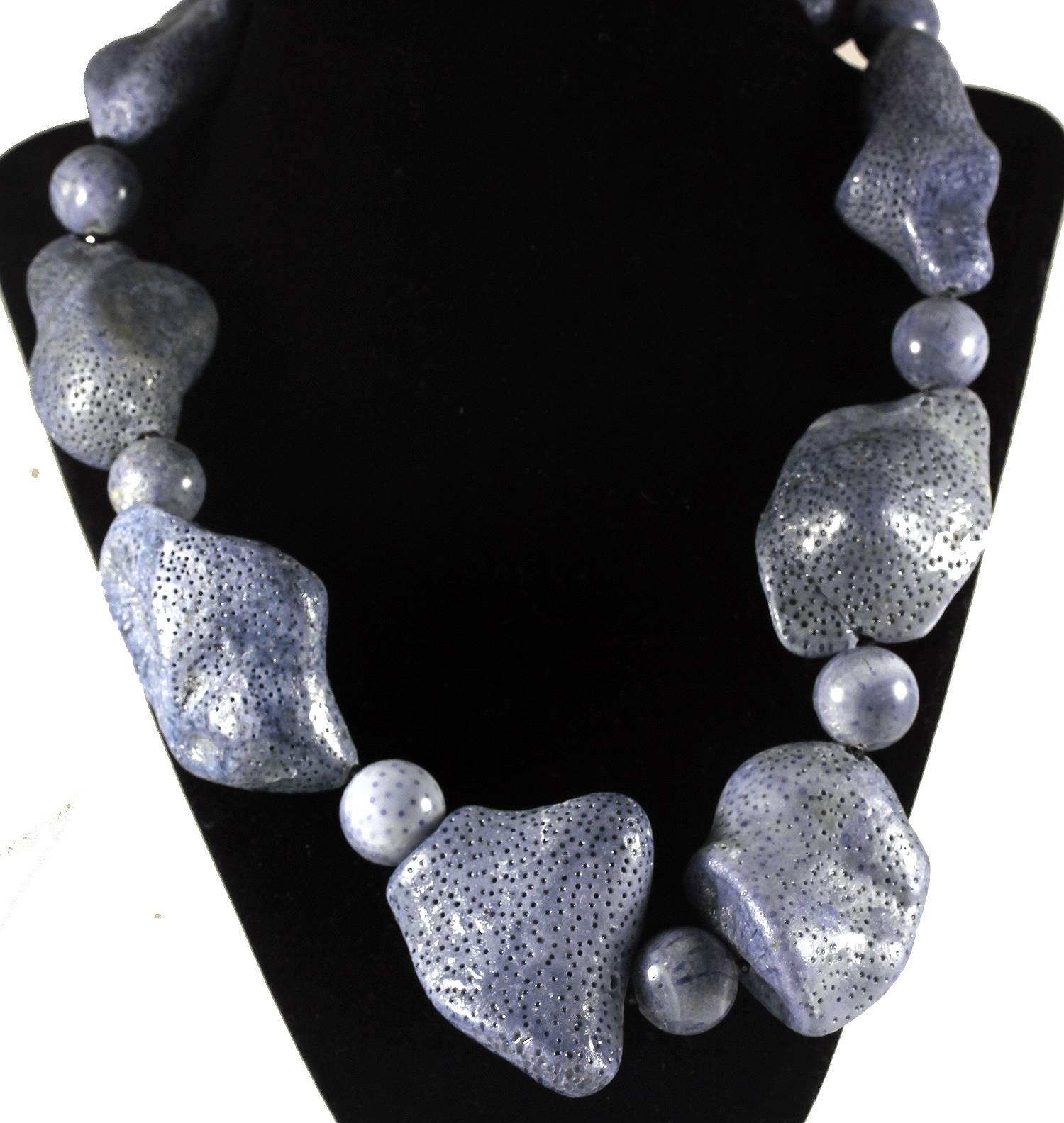 Large polished uneven chunks of natural Blue Coral with tiny sparkly black Spinel accents.
Size:  largest piece 46 mm x 39 mm
Length:  21 inches
Clasp:  Sterling Silver inlaid with tiny diamonds