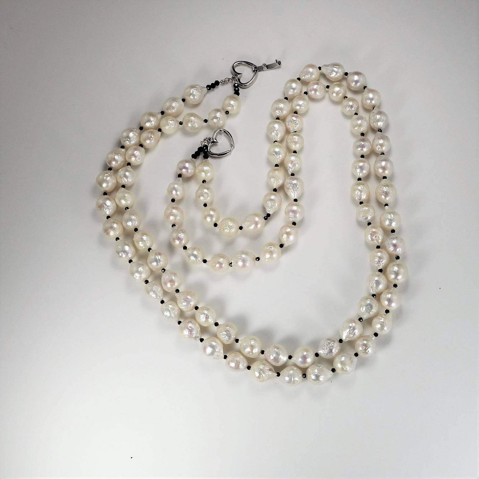 
This lovely 25 inch necklace of Two strands of White Fireball Pearls is a delight to wear. The pearls stand out with tiny black faceted spinel beads between them. It's an updated classic look. Pearls are always in style and this necklace will