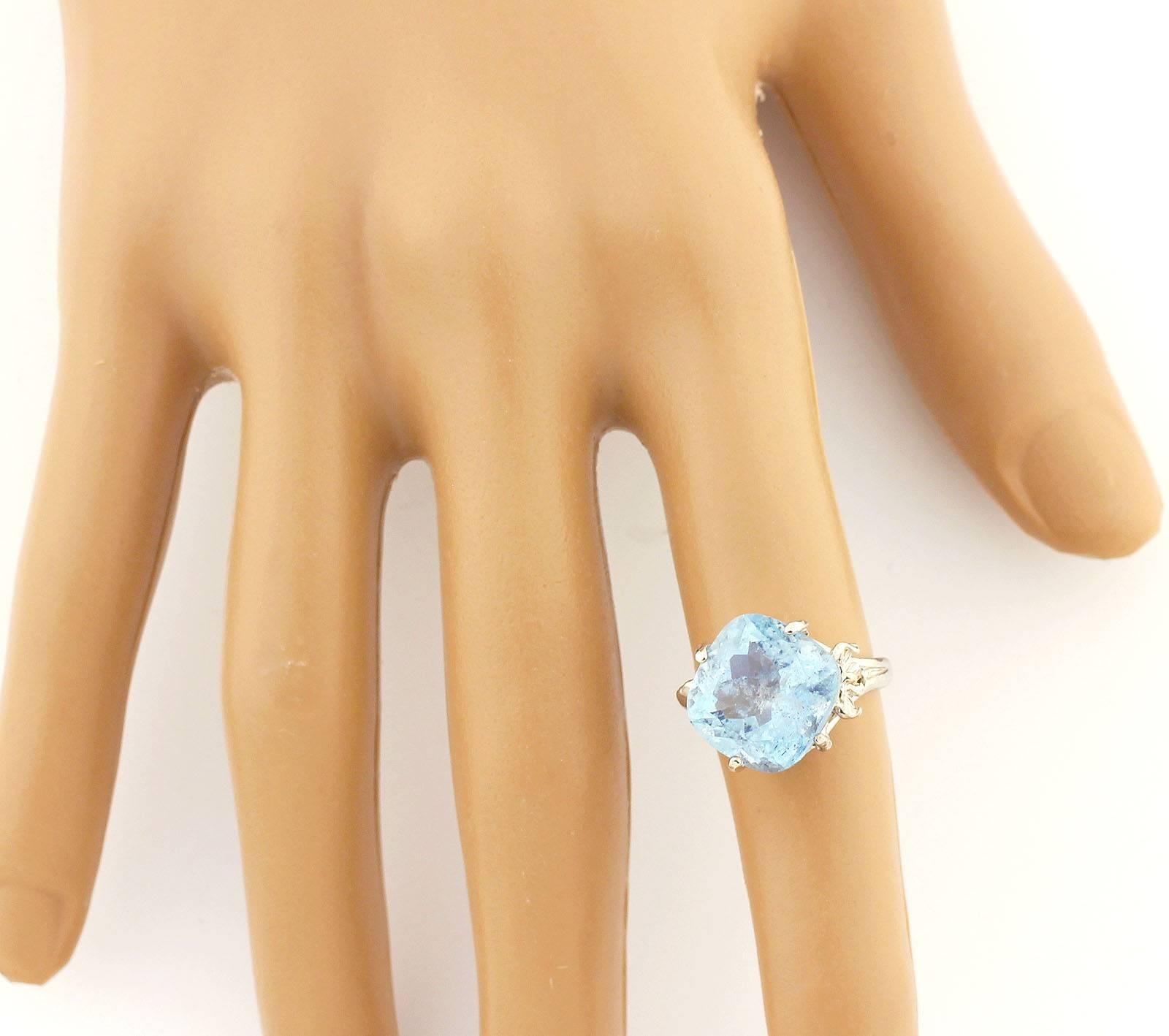 Approximately 6.5 Carats Brasilian Aquamarine ring is sure to turn heads. Beautifully faceted, the aquamarine stands center-stage. It does have some tiny inclusions but glows brilliantly Blue.
Size:  12.5mm x 12.5 mm
Ring:  Handmade in Sterling