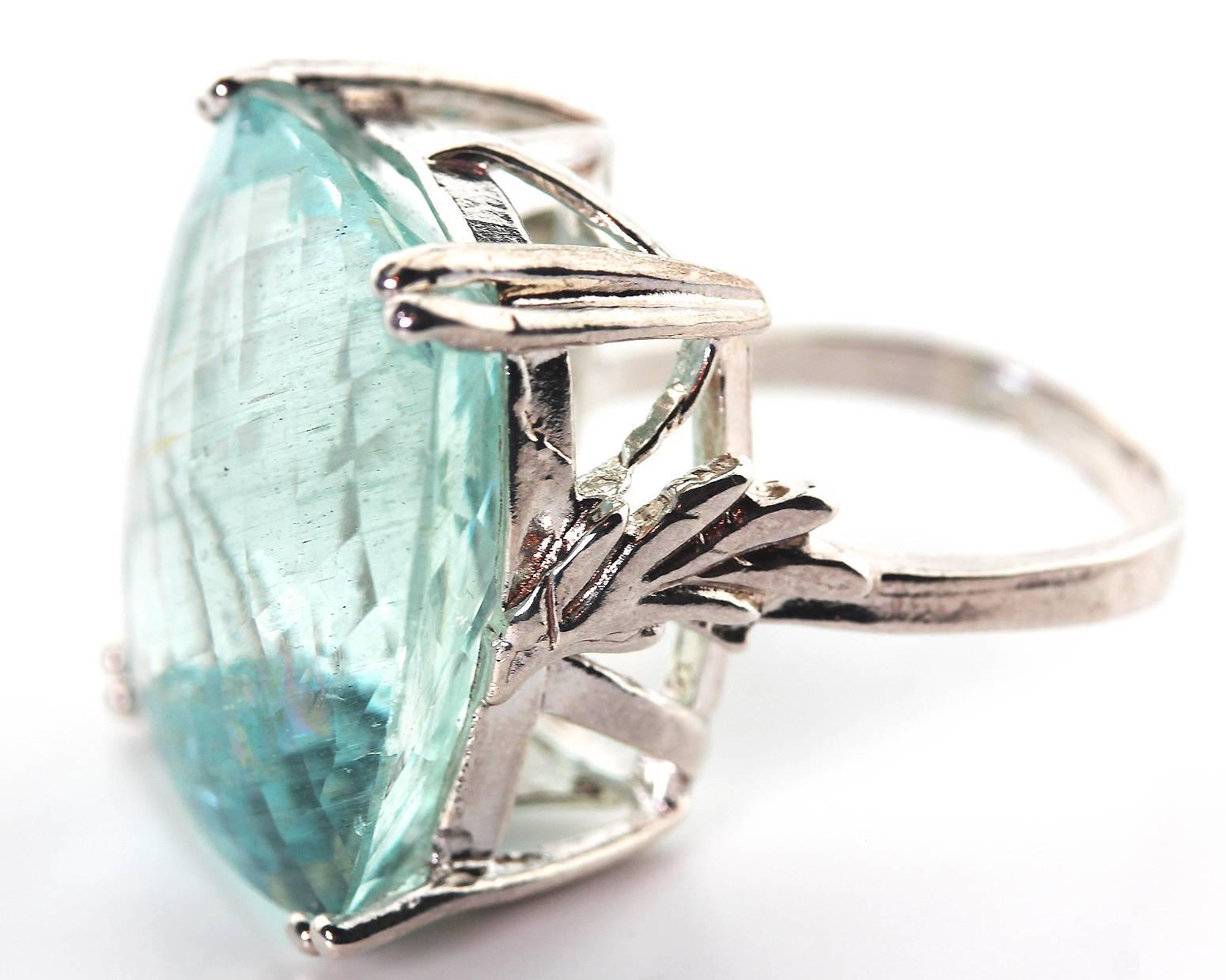 28.5 Carats of magnificent translucent sparkling checkerboard cut natural Aquamarine ring.  The photograph reflects some of the light from the camera.  This does not have a dark mark
Size:  20.7 mm xx 19 mm
Ring:  Sterling Silver
Ring size:  5.75