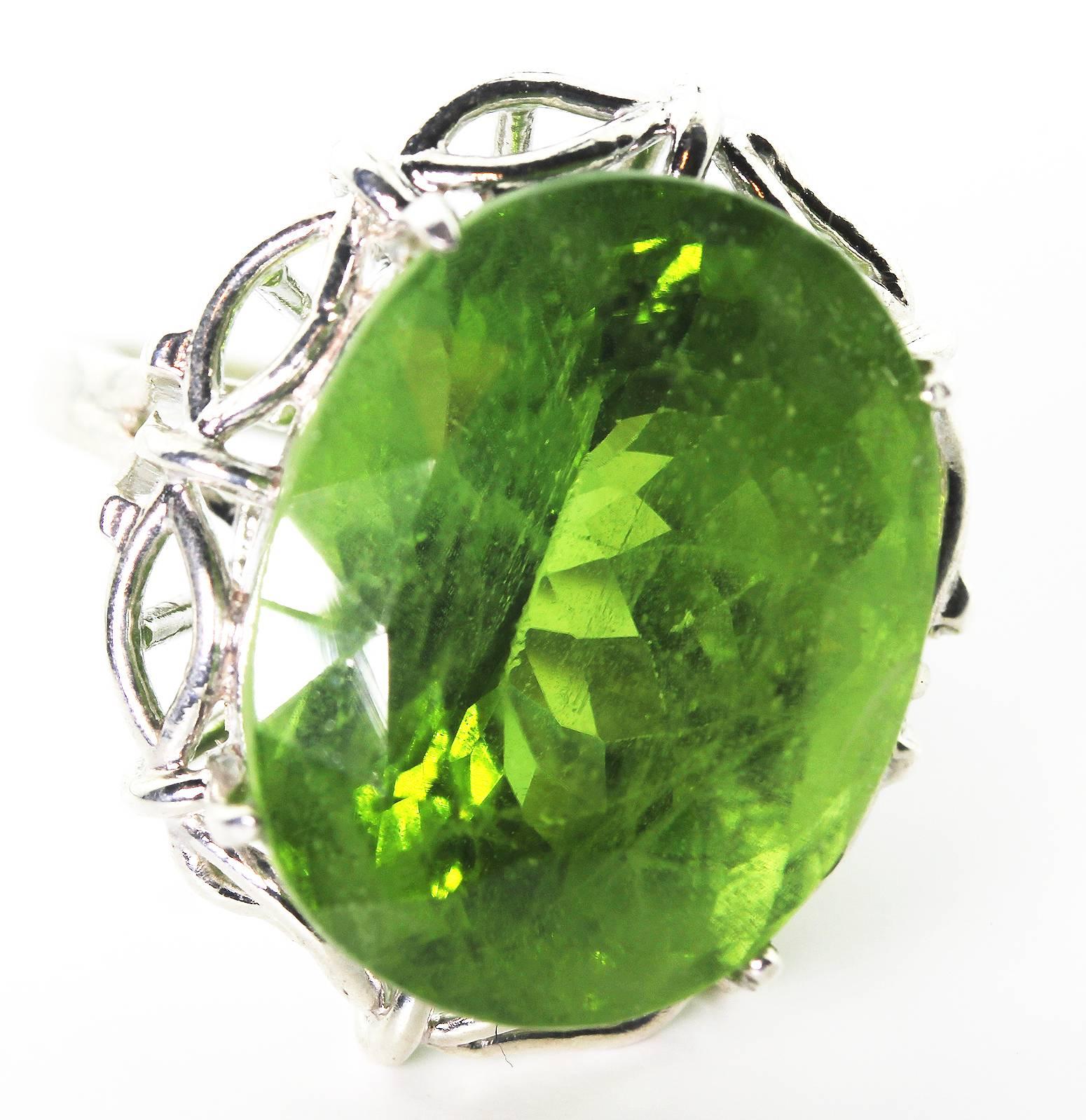 This unique splendid 35.4 carat natural translucent gemmy brilliant green Peridot enchants everyone who looks at it.  Due to its unusual huge size it is happy to go to all occasions. 
Size:  20.5 mm x 16 mm
Ring:  This handmade ring is Sterling