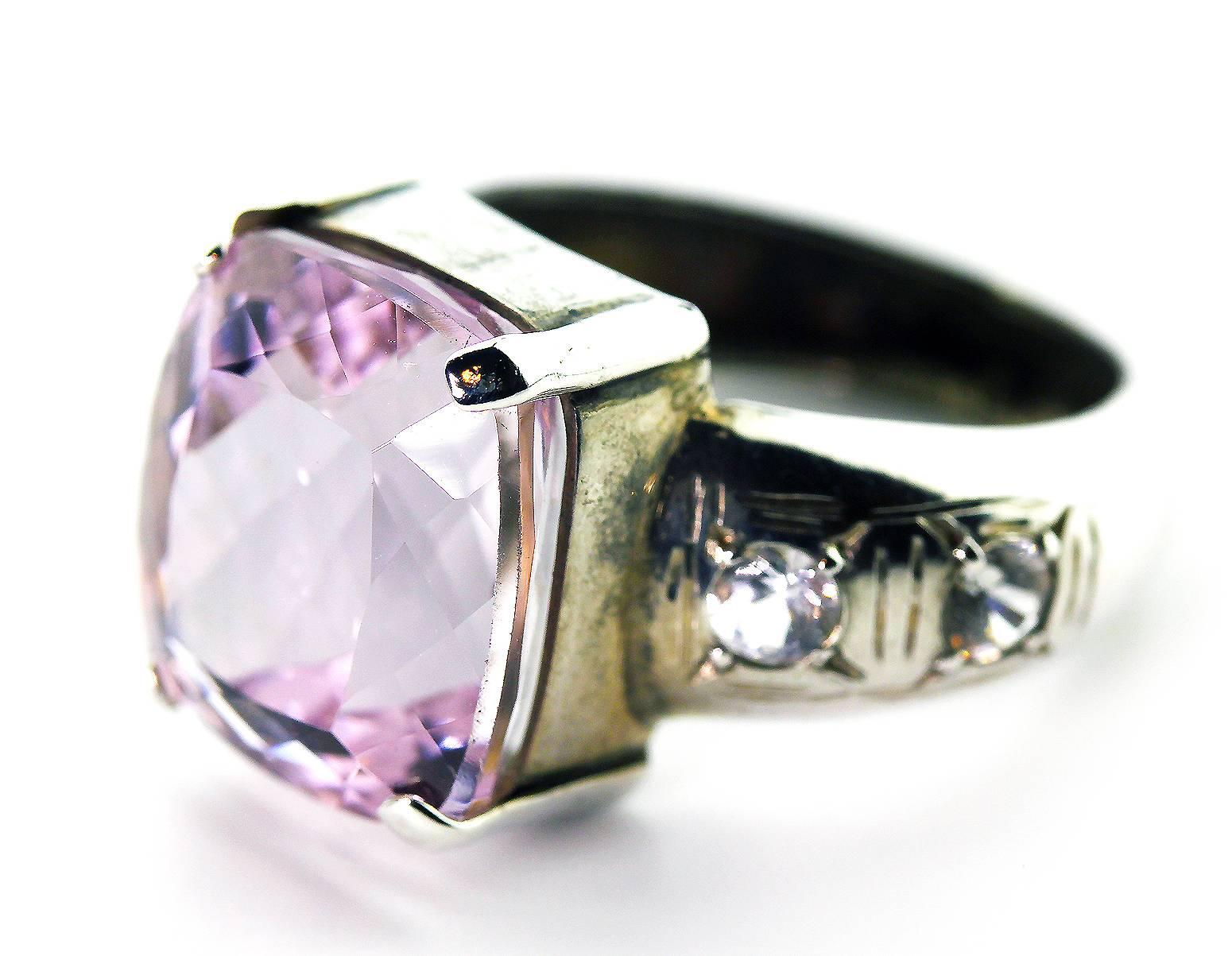 Unique Purplypink glittering natural 9+ Carat Kunzite adorned with sparkling White Sri Lankan Sapphires set in handmade Sterling Silver ring. As there are no eye visible inclusions it is perfect for daytime into evening events. 
Size:  13.2 mm x