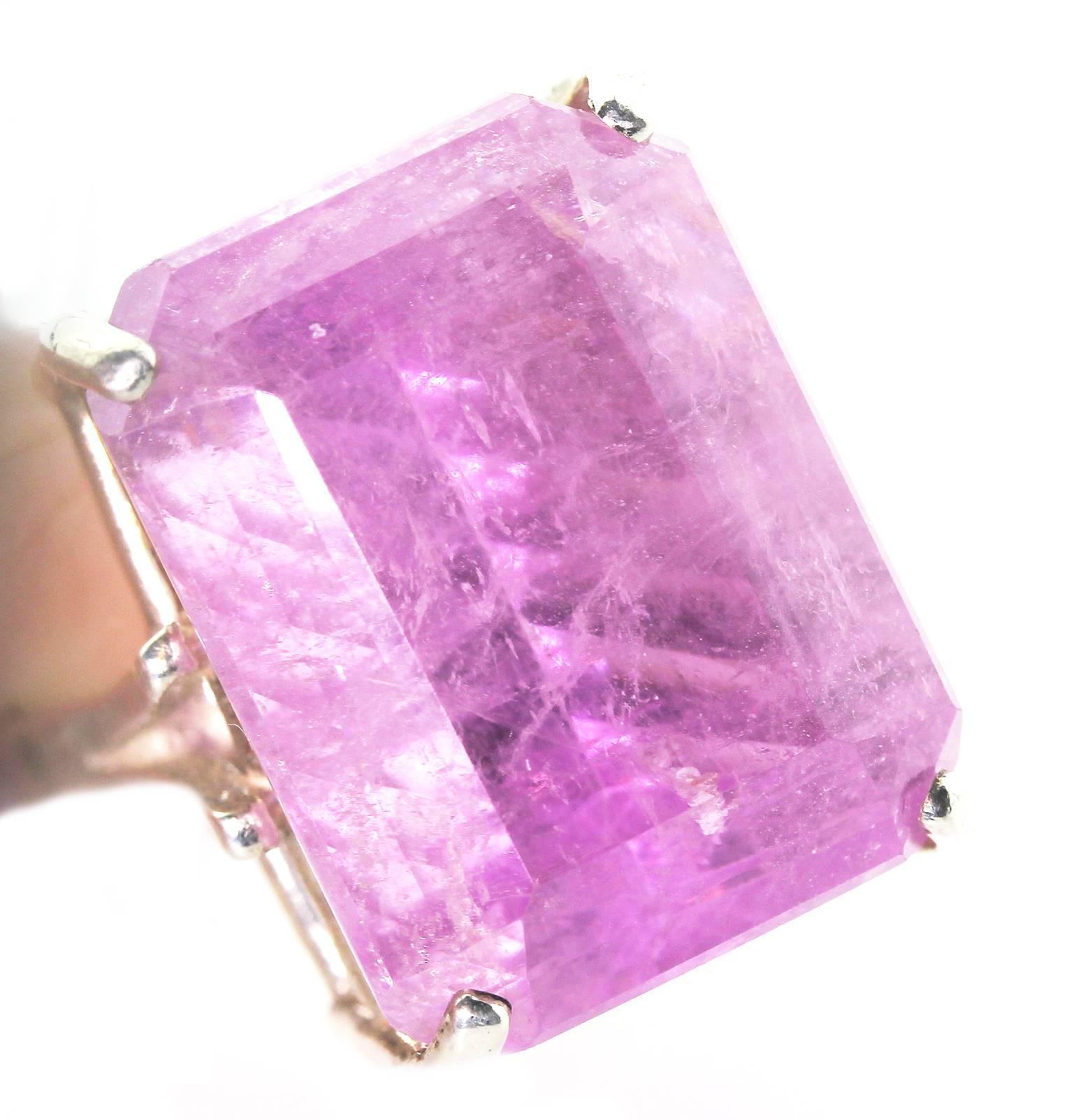 This unique 22.06 Carat natural thick pink glowing Kunzite has an unusual but delightful cut so that it sparkles directionally when you look directly at it.  It is perfect for daytime into evening events.  Size:  19.75 mm x 15 mm in Handmade