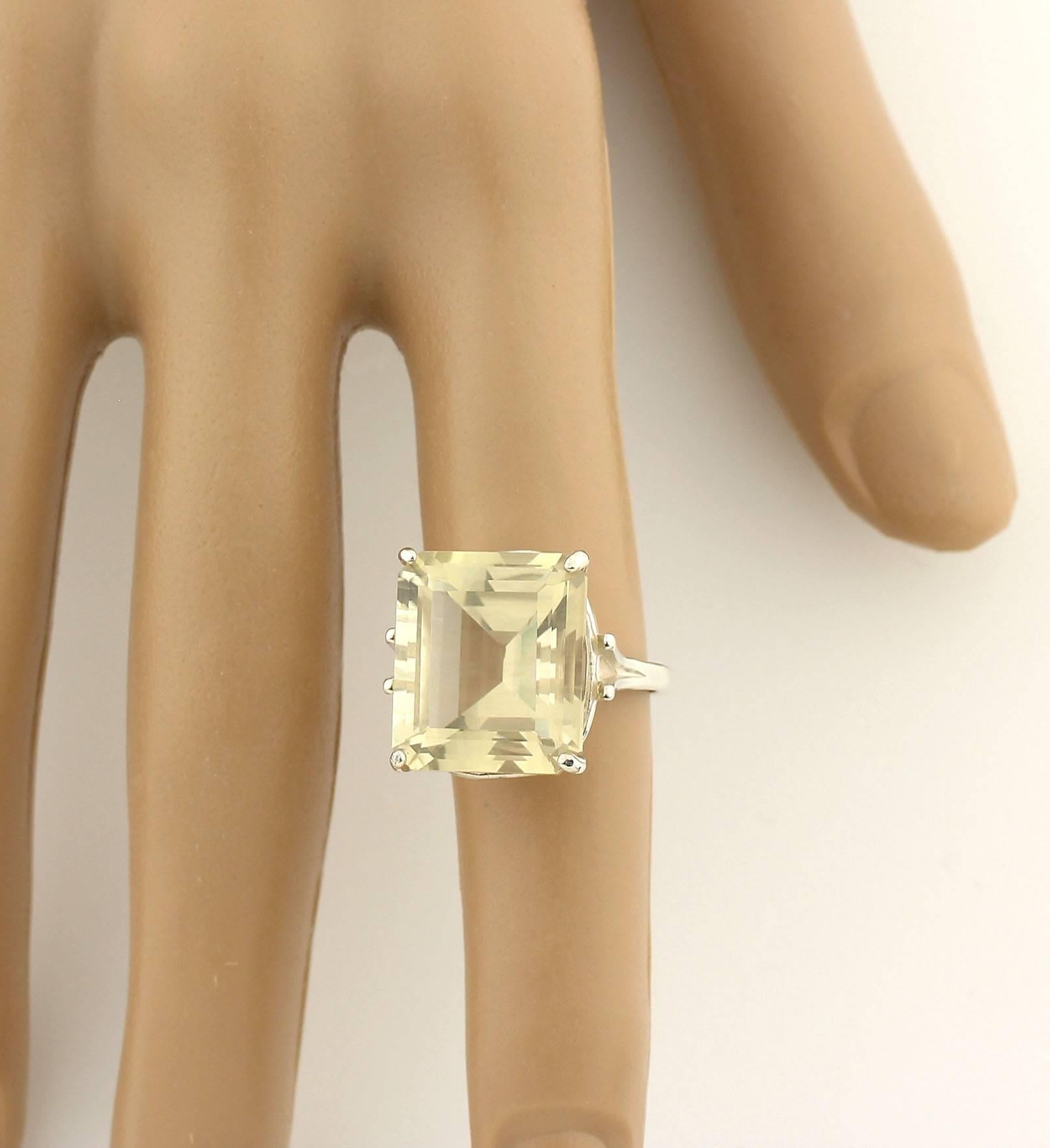 Large 16+ Carat glistening unique emerald cushion cut natural Lemon Quartz handmade ring with no visible inclusions..
Size:  14 mm x 16 mm
Ring;  Sterling Silver
Ring size:  7 sizable
