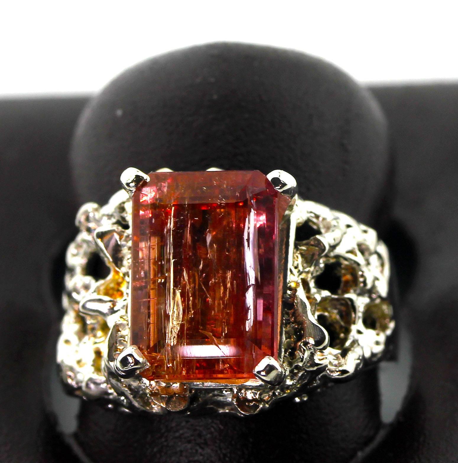 Coming directly from the mines in Minal Gerais near Ouro Preto Brasil, this beautiful natural translucent sparkling pinkyorangy 5.35 Carat emerald cut Imperial Topaz is sent in an antique Sterling Silver ring .  Its so bright it reflects the camera