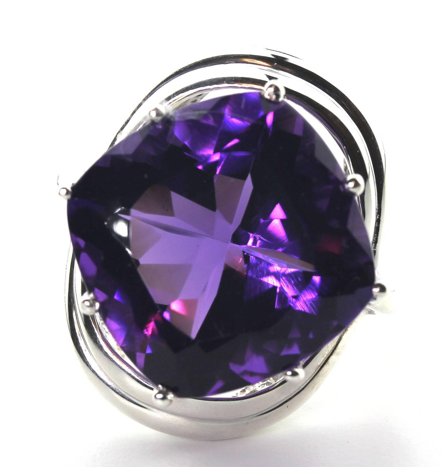 This deeply purple hugely sparkling 16 Carat square cut exceptional flawless African Amethyst is 17 mm x 17 mm set in a beautiful sweeping Sterling Silver ring.
Ring size:  7.25 sizable
