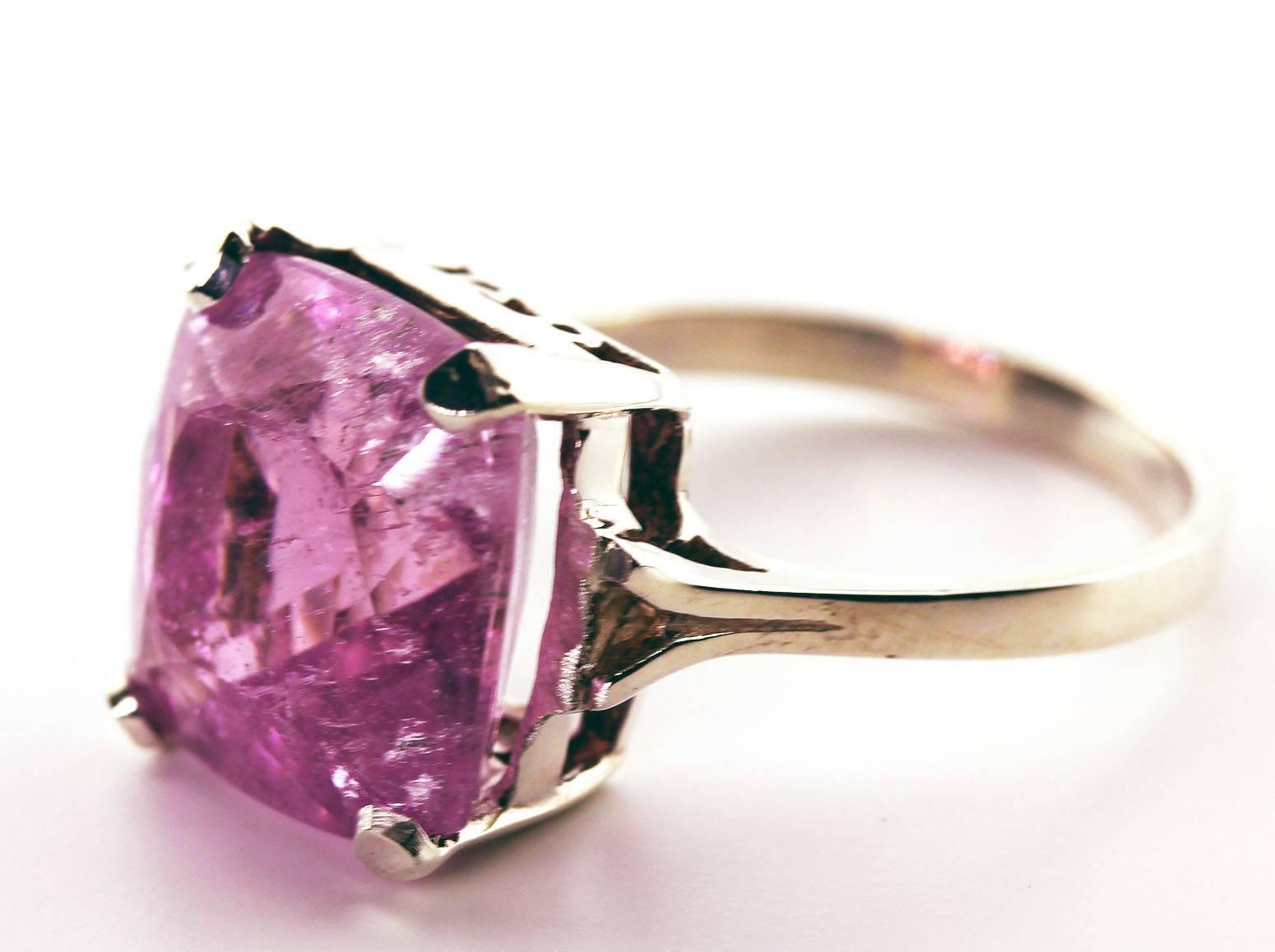 This 13.1 Carat unique pink pink pink cushion cut brilliant visually flawless looking Kunzite is 14 mm x 14 mm and is set in handmade Sterling Silver ring to enhance the sparkle of the gemstone.  The ring size is 9.5 sizable.  