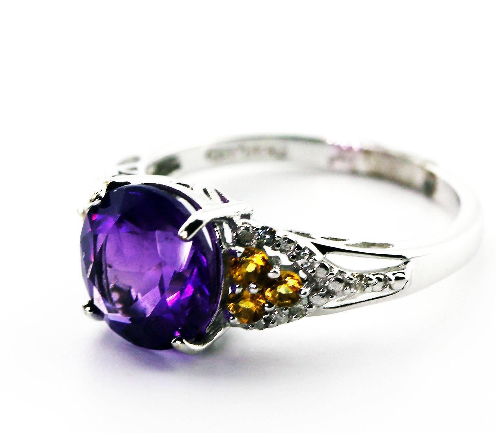 Sparkling 2.4 Carats of brilliant purply pink Amerthyst adorned with 10 KT white gold setting with tiny Diamonds and Citrines.  The Amethyst is 9 mm and the ring is a sizable 7.  