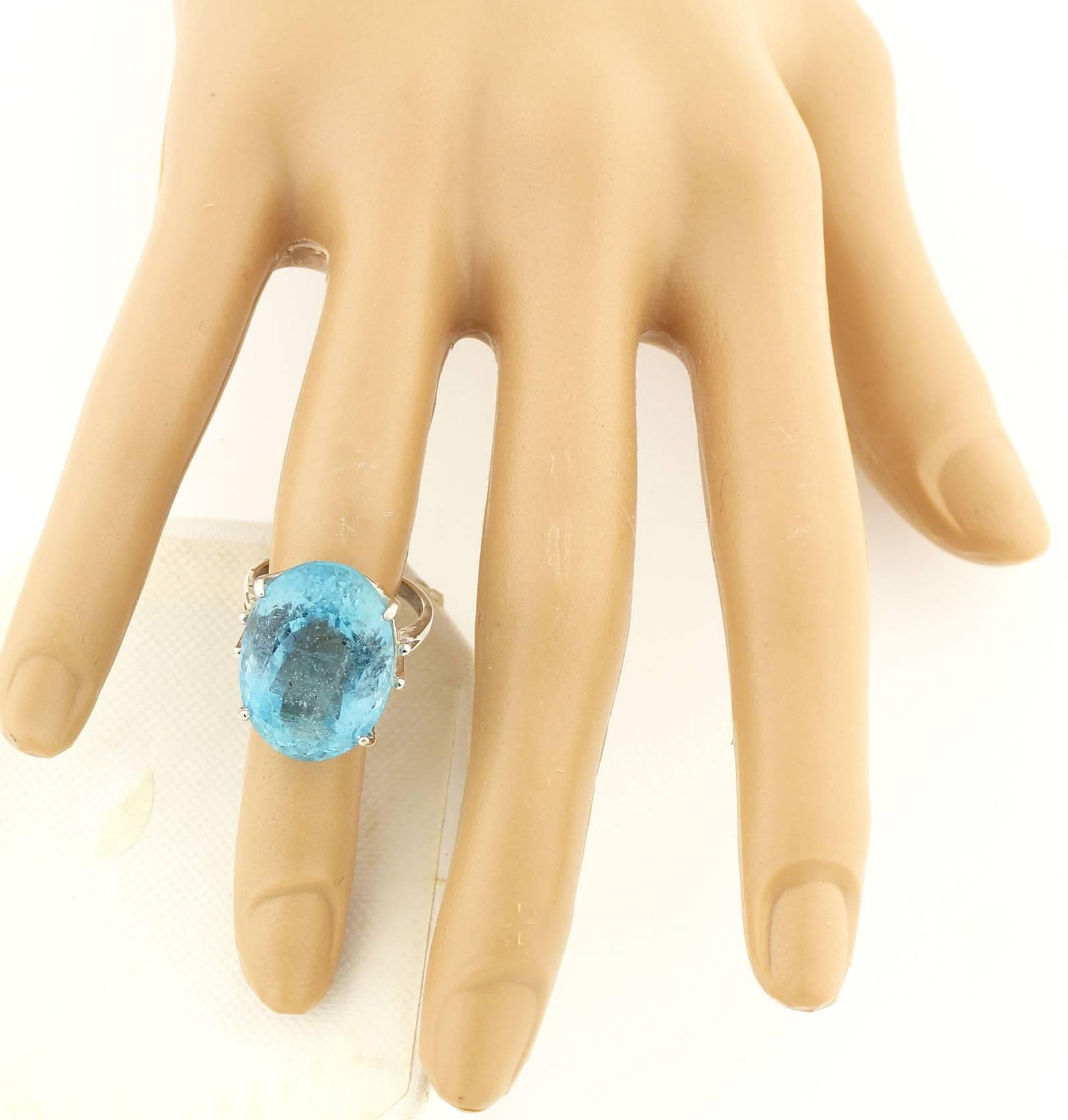 This unique beautiful Aqua Blue 25.16 Carat natural oval Aquamarine from the famous Santa Maria mine in Brasil is set in a Sterling Silver ring.  It measures 21.3 mm x 15.68 mm and the ring is a sizable 7.  This gemstone is practically flawless and