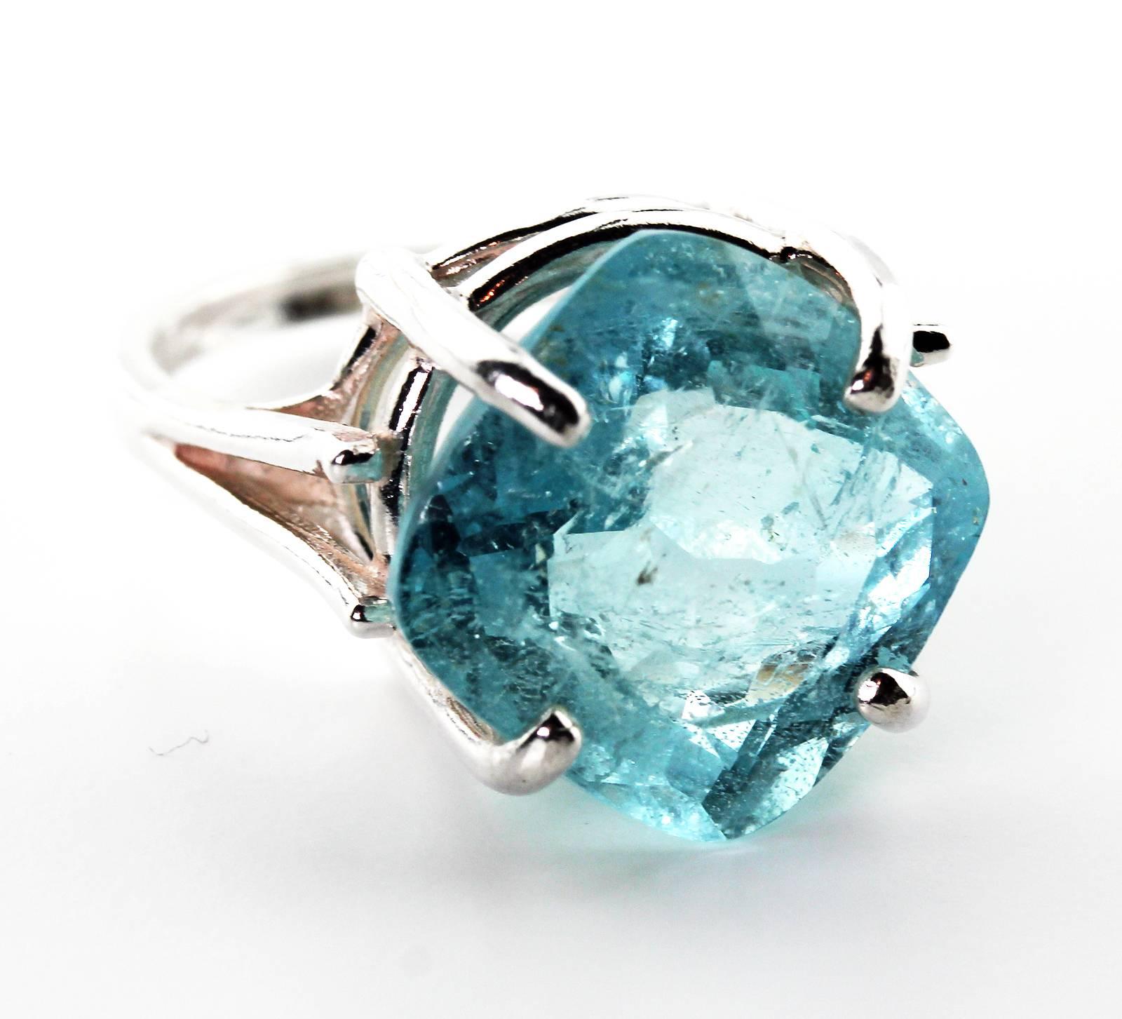 This lovely translucent bright blue 10.59 Carat square cushion cut Brasilian Aquamarine, measuring 13.5 mm x 13.5 mm, is set in a unique Sterling Silver ring size 7 (sizable).  More from this seller by putting gemjunky into 1stdibs search bar.