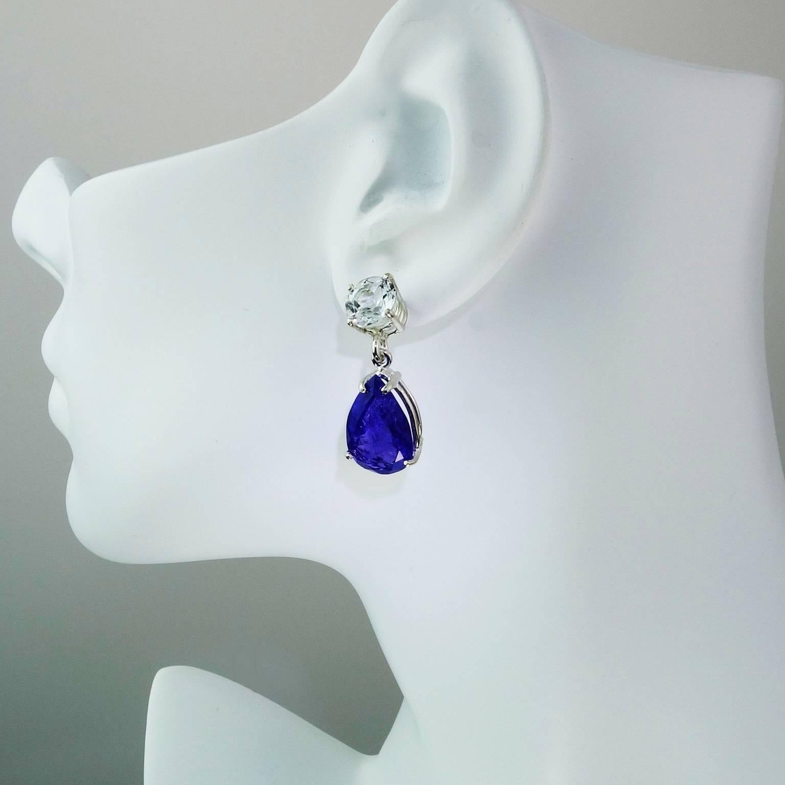 Lively Pear Shaped Tanzanites (13.73ct) and Sparkling Round Silver Topaz (8MM) together in Statement Dangle Earrings. The gemstones are set in Sterling Silver.  The Tanzanites have the natural inclusions typical of tanzanites which help reflect the