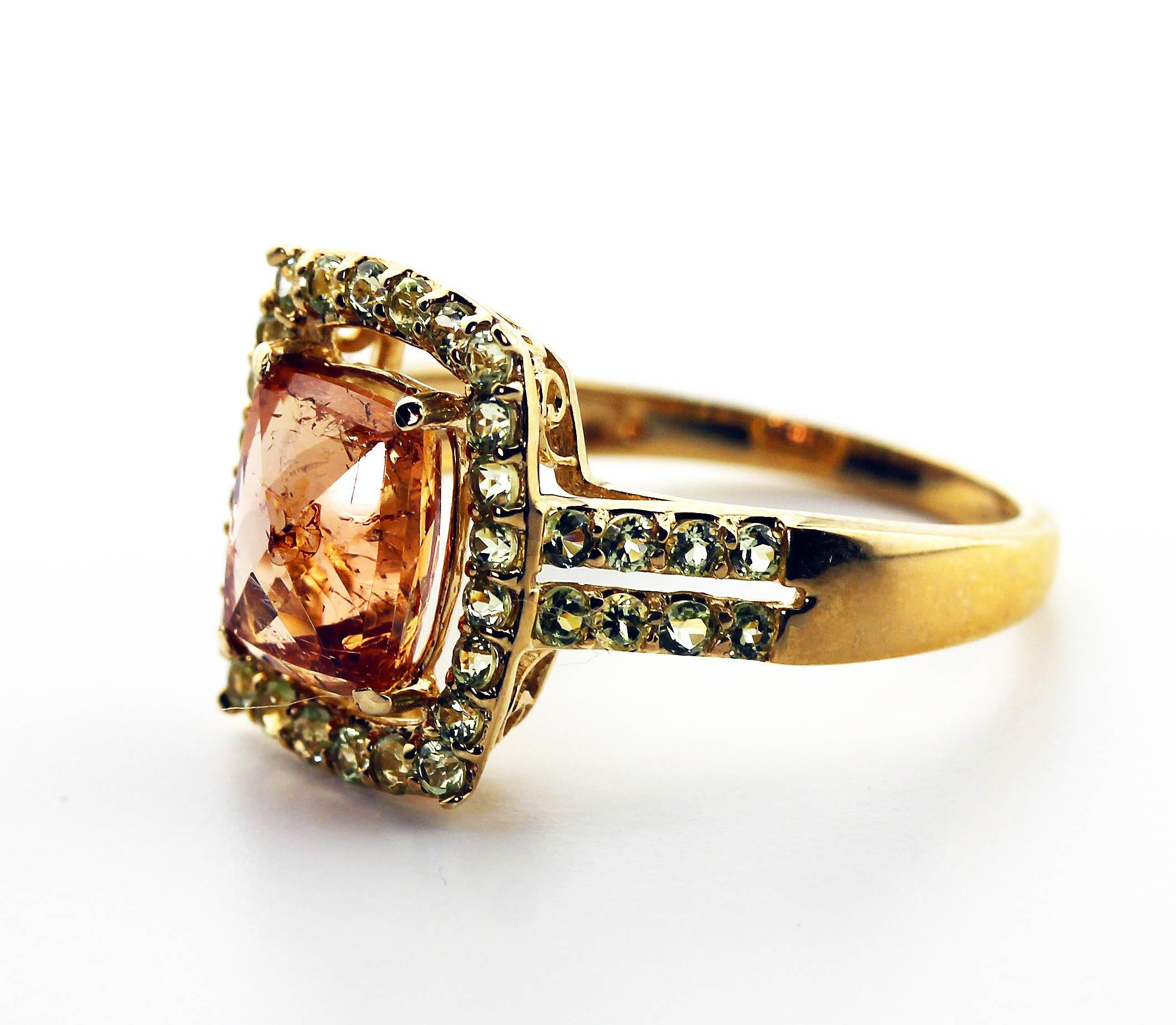 This magnificent rare 2.61 translucent sparkling Brasilian Imperial Topaz adorned with tiny Diamond accents set in a unique handmade 10 Kt yellow gold ring size 7 (sizable).  This gem is so clear it reflects light from every source and its own gem