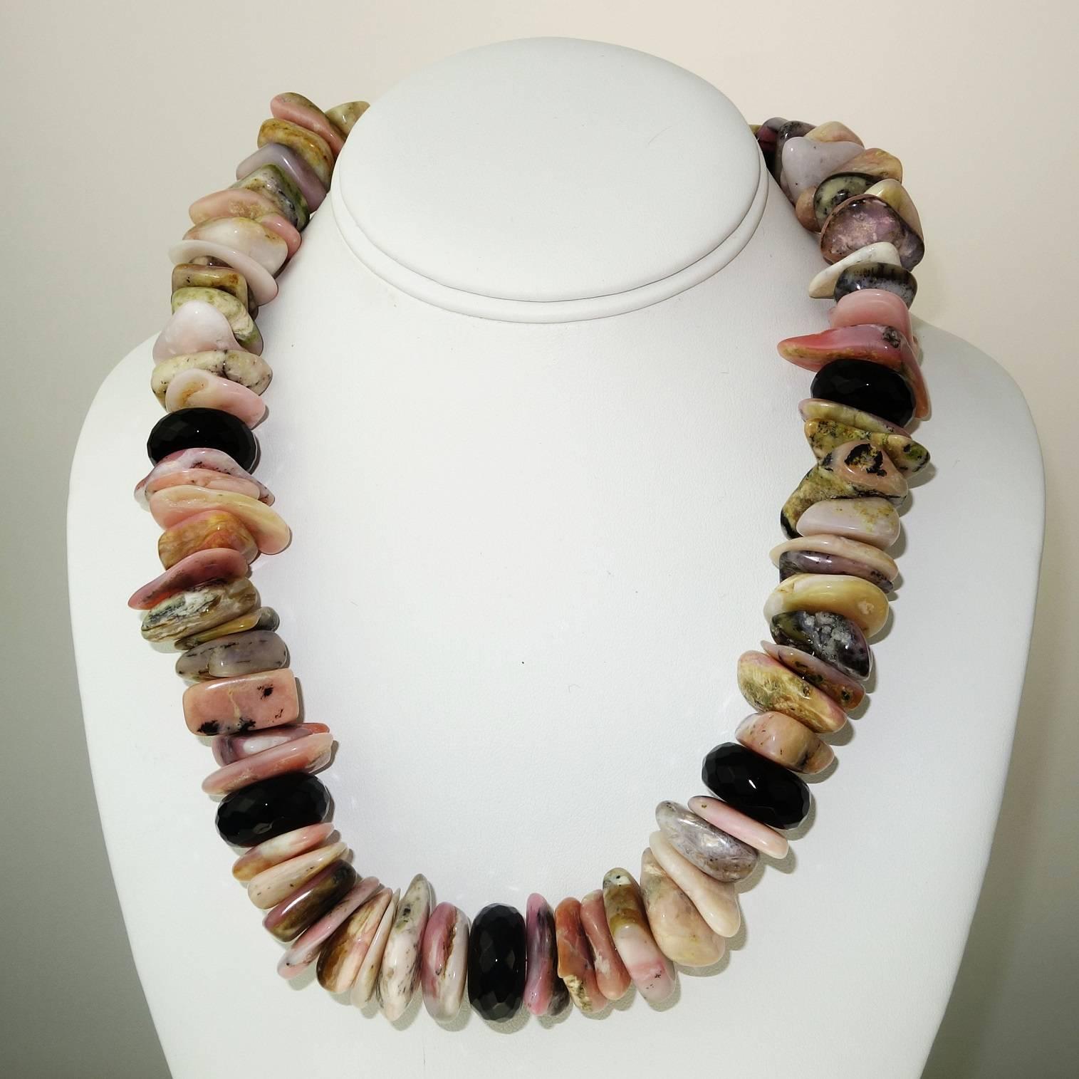 Tumbled, polished chunkly slices of Pink Peruvian Opal Necklace with Shiny 
 Faceted Black Onyx accents. Statement necklace of 20.5 inches in fabulous shades of pink. The matrix in some of the gemstones enhances the unique character of the necklace.