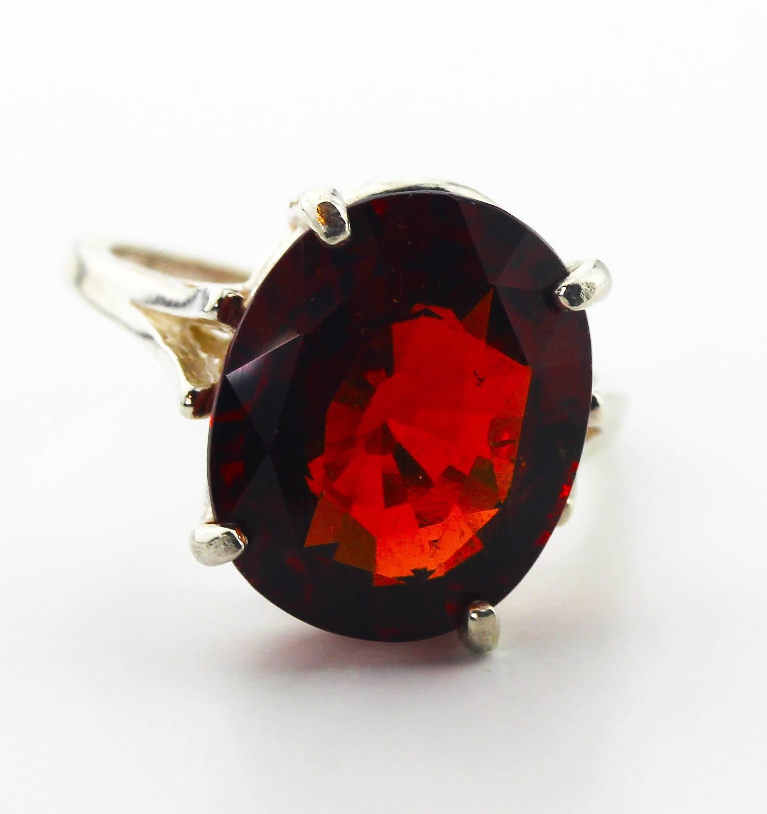 Brilliant rare red 10.75 Carat Hessonite Garnet set in a Sterling Silver ring.  The ring is a sizable 7.