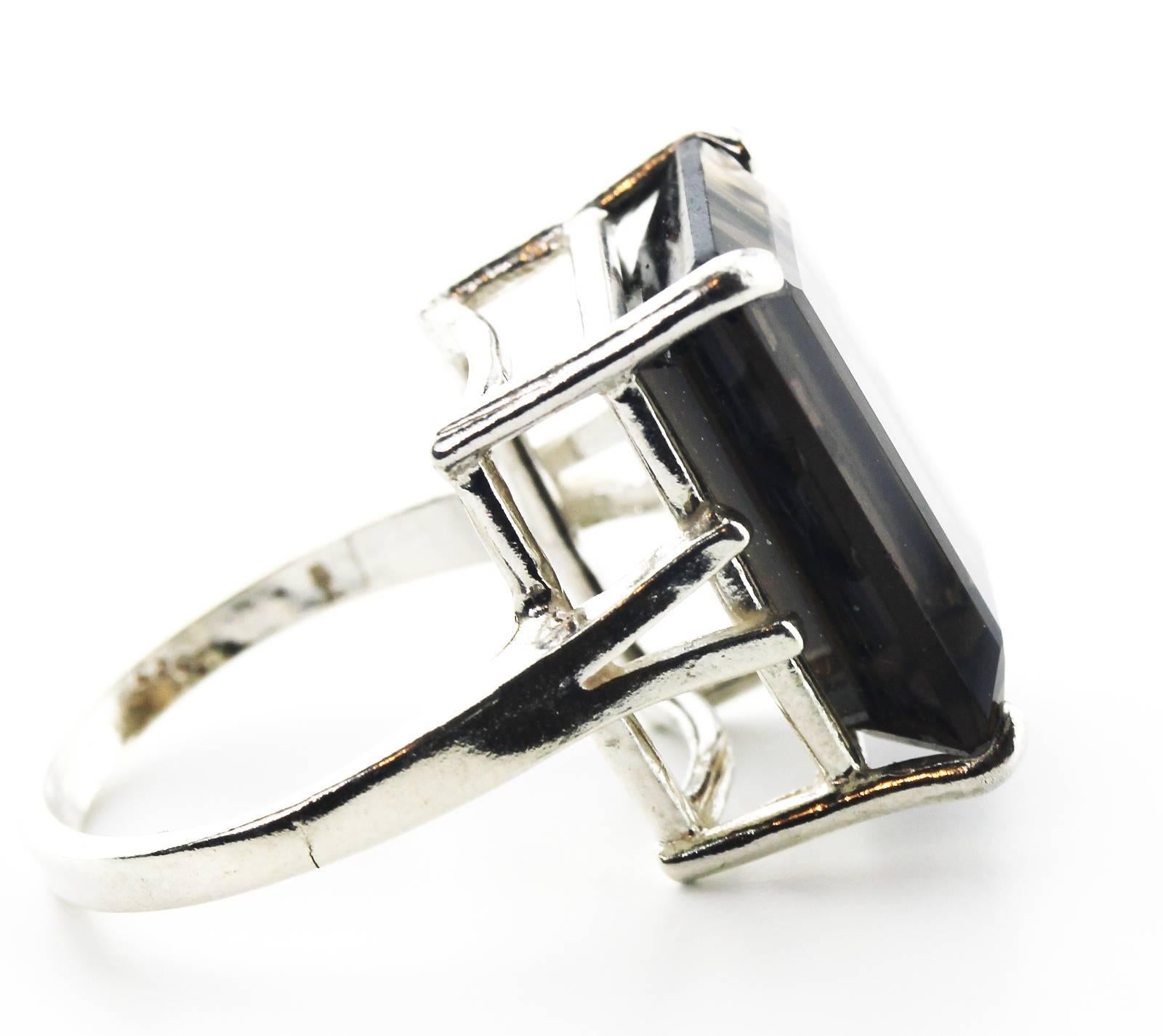 This sparkly huge 13.2 Carat natural emerald cut Smoky Quartz is set in our unique handmade Sterling Silver ring.  The ring is a size 7 (sizable)  More from this seller by putting gemjunky into 1stdibs search bar.