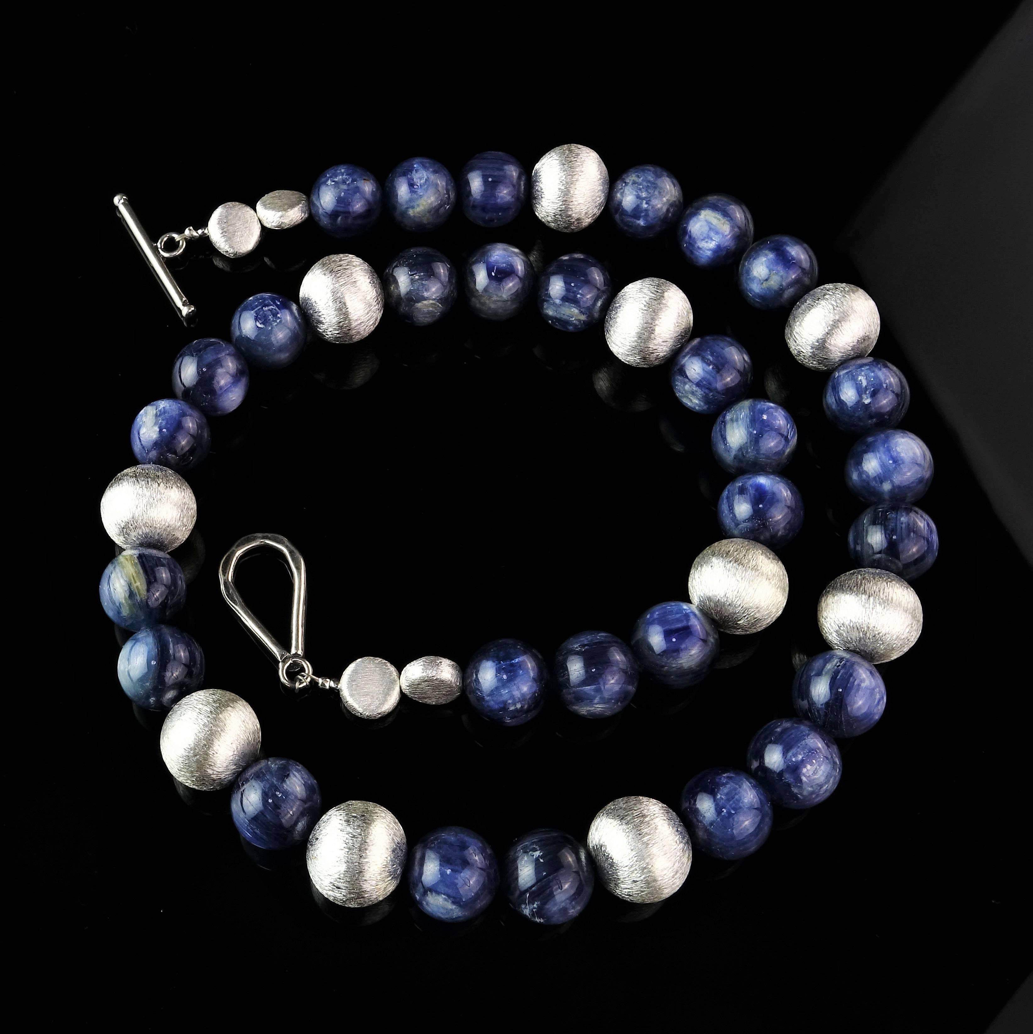 Glowing Blue, highly polished Kyanite Beads in a flowing 26 inch necklace secured with a Sterling Silver hoop clasp. These Kyanite beads are beautifully fibrous and matched with similarly fibrous silver tone beads. Wear this necklace everywhere and
