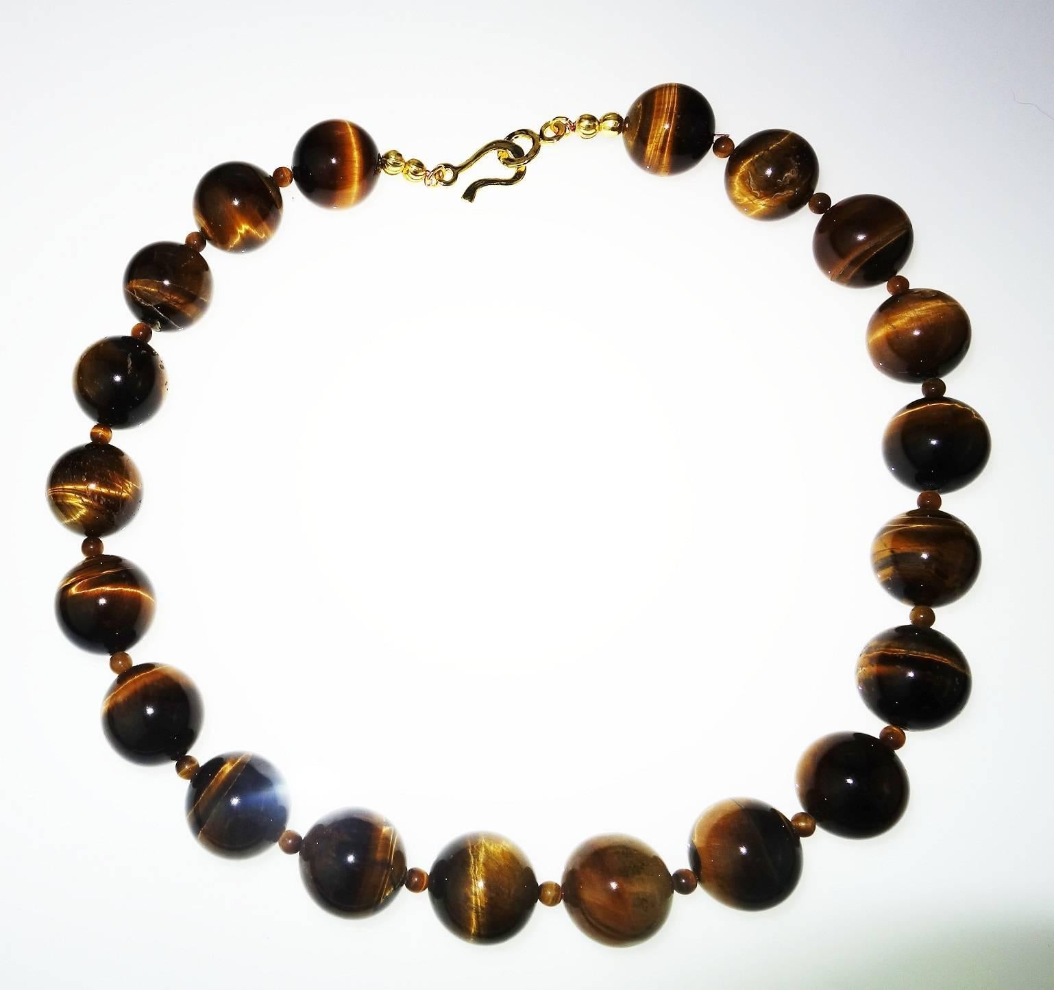 20MM Highly Polished Tiger’s Eye Necklace with 18Kt yellow gold hook and eye clasp.  These magnificent Tiger’s Eye beads are enhanced with more Tiger’s Eye 4mm accents. The necklace measures 21.5 inches.  