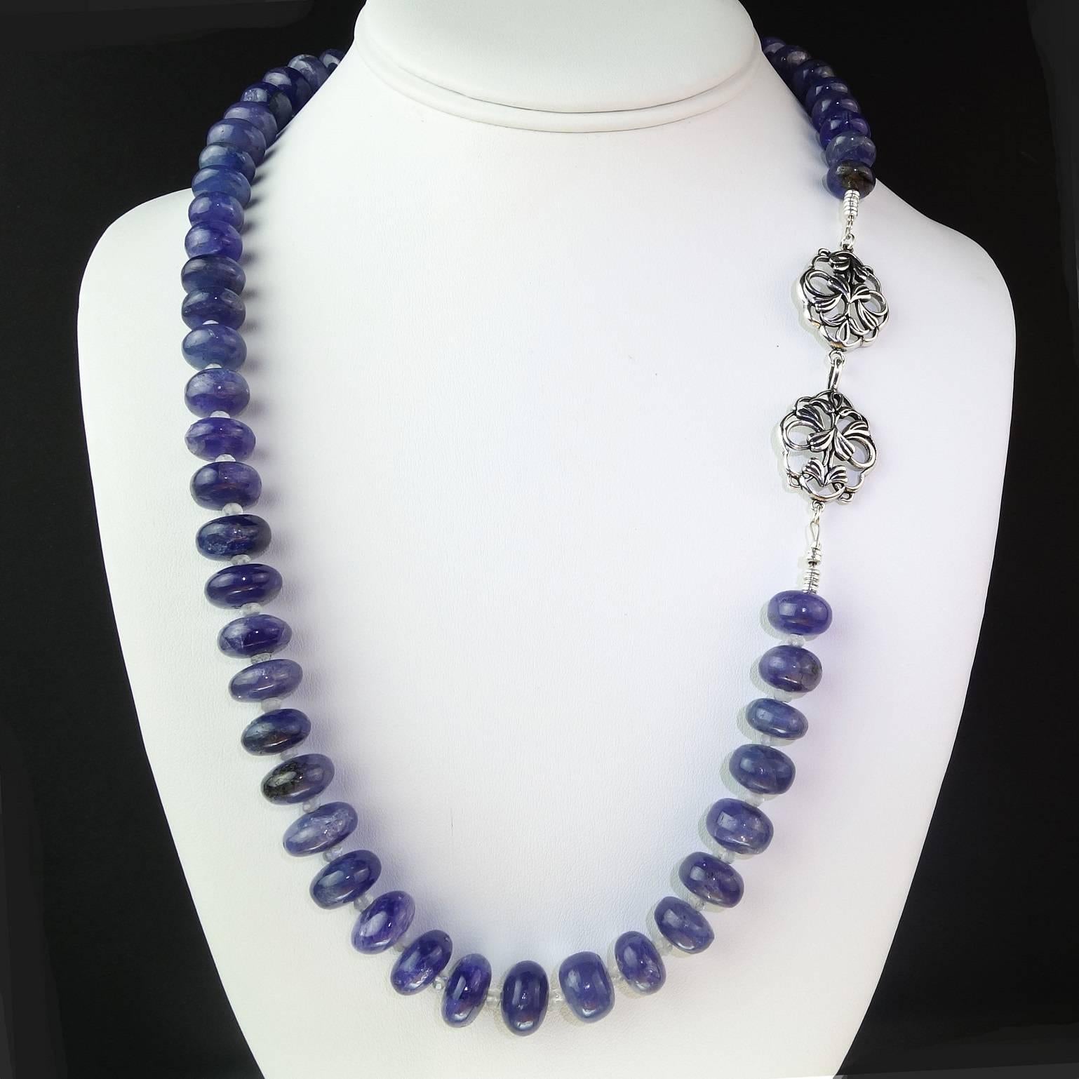 23.5 Inch Necklace Cabochon Rondel Tanzanite accented with faceted Moonstones.  These are highly polished and translucent gemstones in a lovely shade of bluish purple. The Tanzanite measures approximately 11MM in size.  The clasp is a double floral