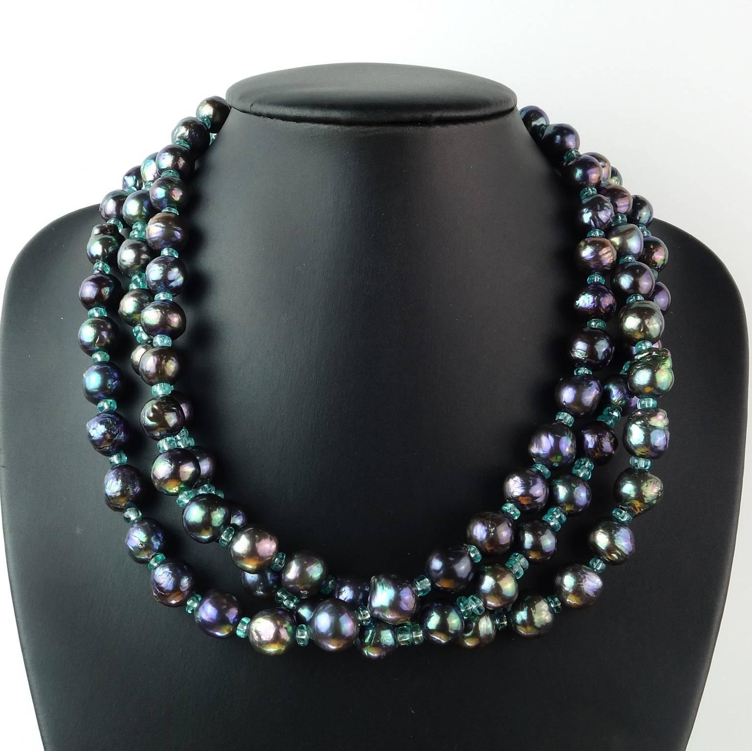 Stunning three strand necklace of blue/green iridescent 10MM pearls accented with faceted 4MM Apatite. The necklace is 18.5 inches in length and can be twisted to make it choker length.  It is secured with a floral motif Turkish Sterling Silver