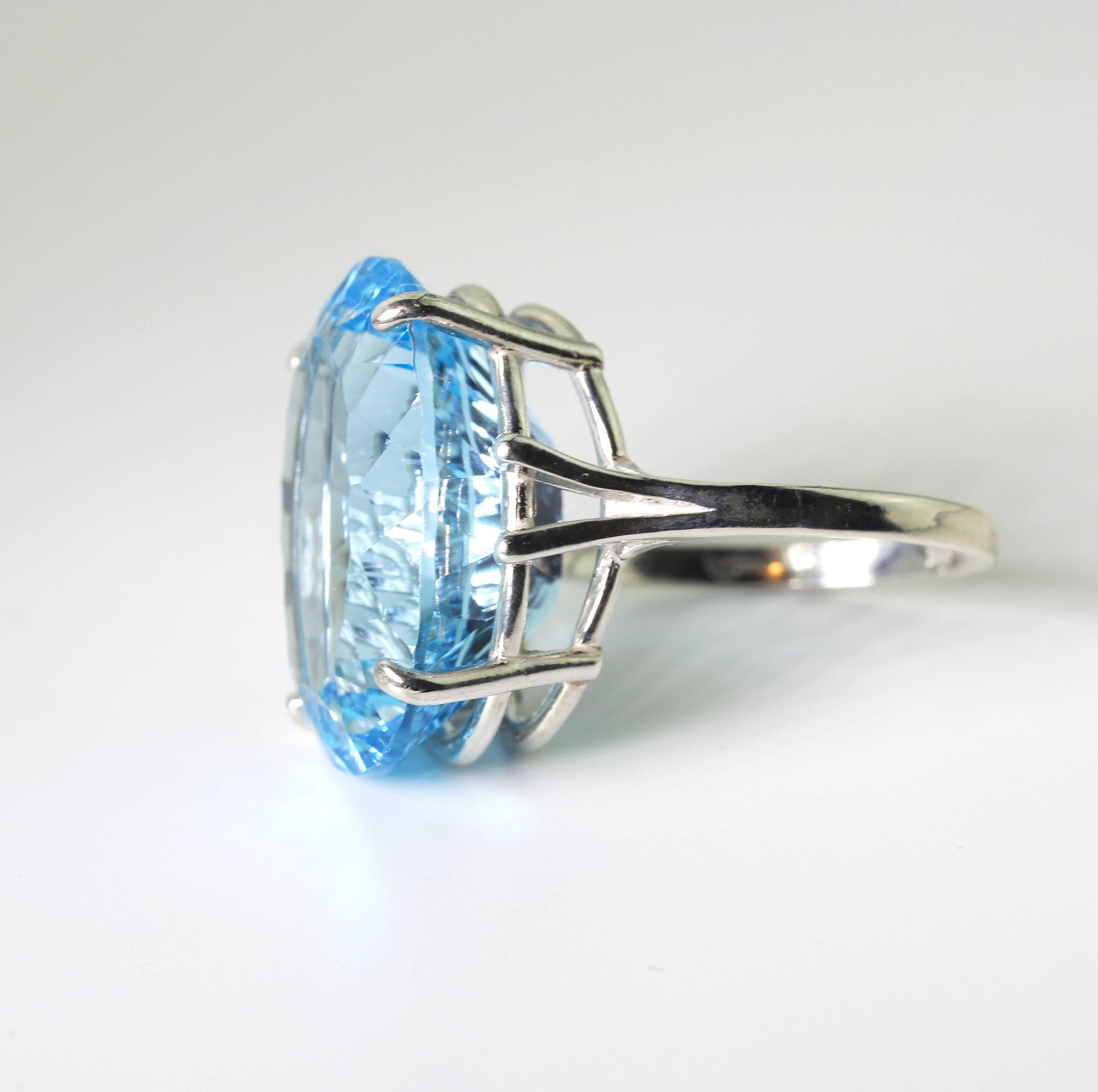 Wowser of a beautiful amazingly cut 22.30 carat Brilliant Blue Topaz set in Sterling Silver ring.  The ring is a size 7 (sizable) and the cut is such that the gemstone glitters from all directions.  There are no visible inclusions.