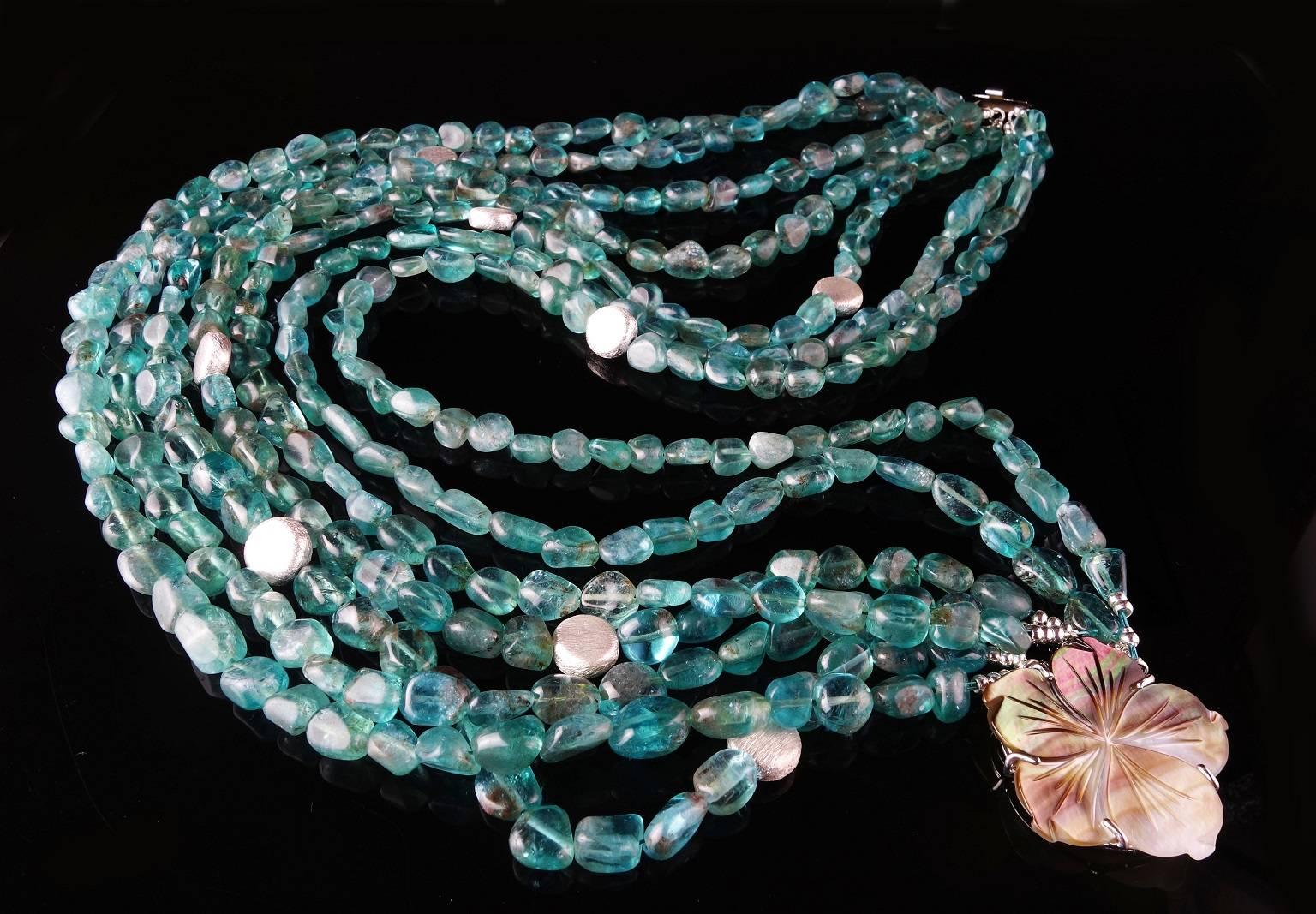 Custom made, seven strands of tumbled, polished transparent Apatite in a very wearable 18 inch necklace secured with a Mother of Pearl clasp. The Apatite strands are accented with the occasional silver tone disc. This unique necklace can be worn