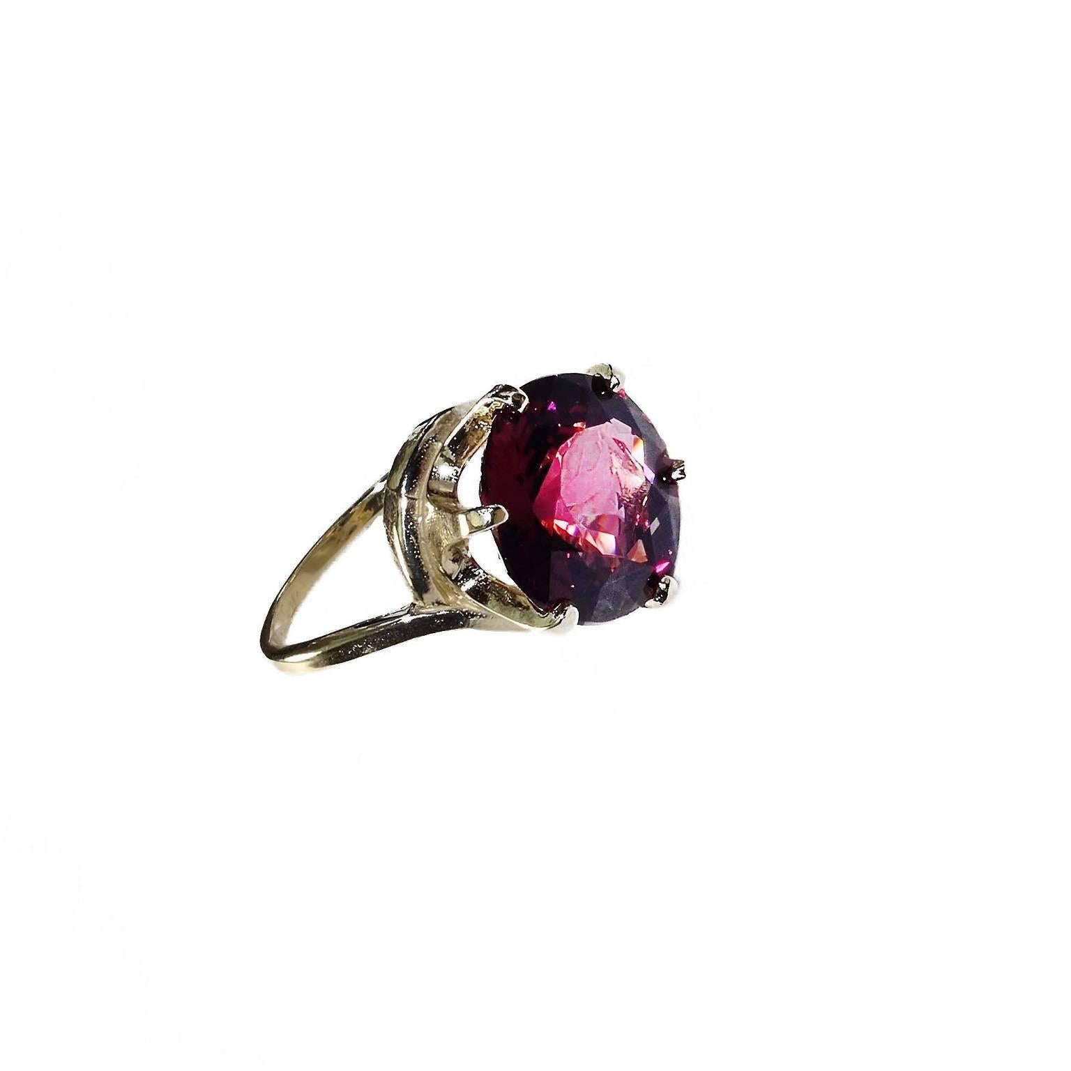 Custom made stunning, sparkling large round brilliant cut Rhodolite Garnet set in six prong  14K yellow gold mounting.  This lively Rhodolite Garnet has beautiful flashes of pink and is an amazingly large size to keep it brightness and life. It