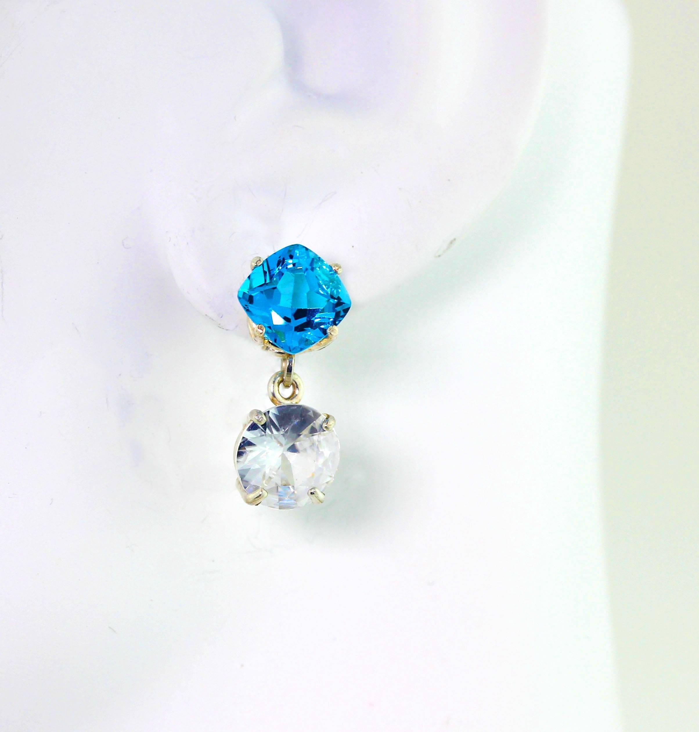 3.72 carats each of glittering round brilliant white Cambodian Zircons (9 mm) swing happily and super elegantly from these 2.61 carats each of glamorous glistening blue cushion cut Topaz (8 mm x 8 mm) set in sterling silver stud earrings. They hang
