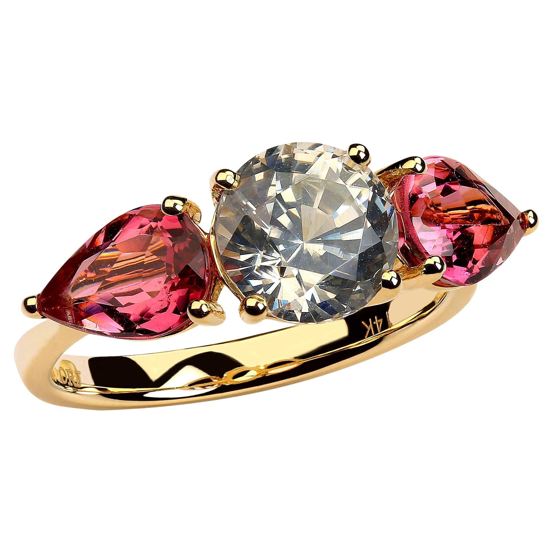 Custom made, romantic ring of sparkling, round White Zircon flanked by two glittering pink pear shaped tourmalines. The tourmalines were sourced from our favorite supplier in the mountains outside of Rio de Janeiro and the total weight is 1.77