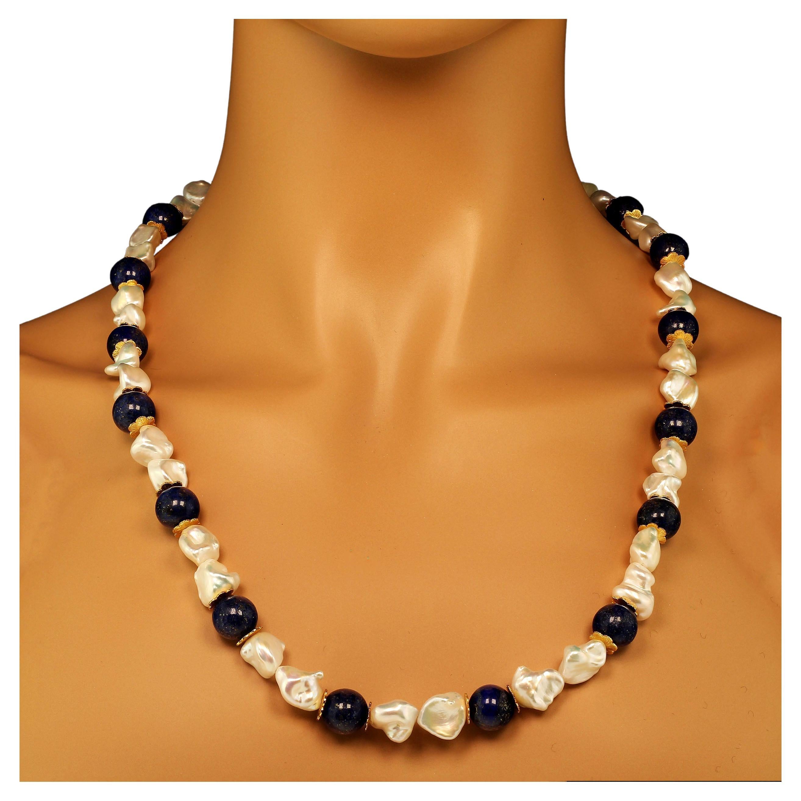 Own the jewelry you wish for

Custom made gorgeous white Keshi Pearl and Lapis Lazuli (12MM) Necklace with goldtone flutters for accents. These unique iridescent pearls flash yellow and pink from their gentle folds.  They are beautiful complements
