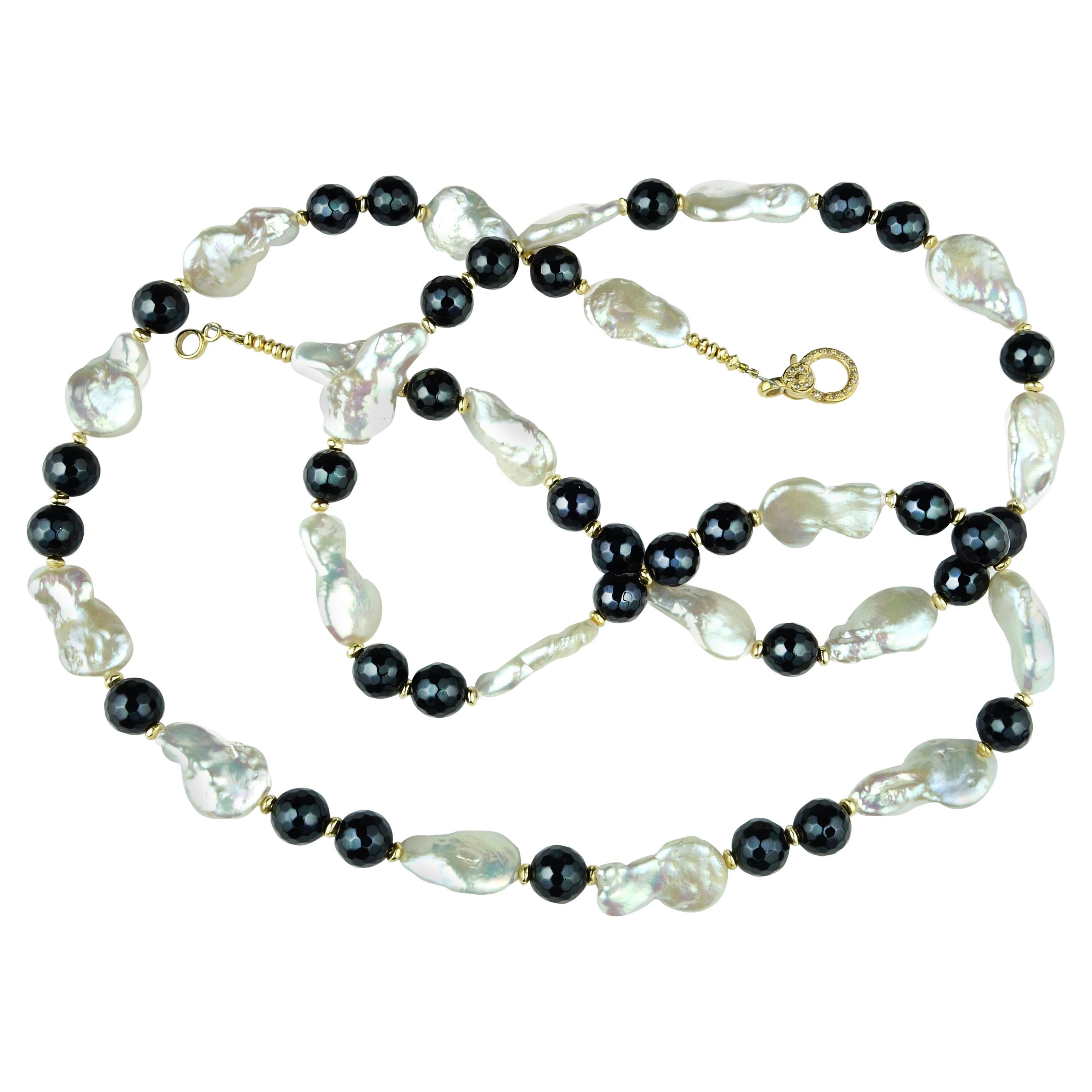 Own the jewelry you wish for

31 Inch, Custom made, striking pear shape Freshwater Pearls and Black Onyx necklace with goldtone accents. The iridescent pear shape Pearls are slightly graduated up to 18MM. The sparkling faceted 8MM Black Onyx beads