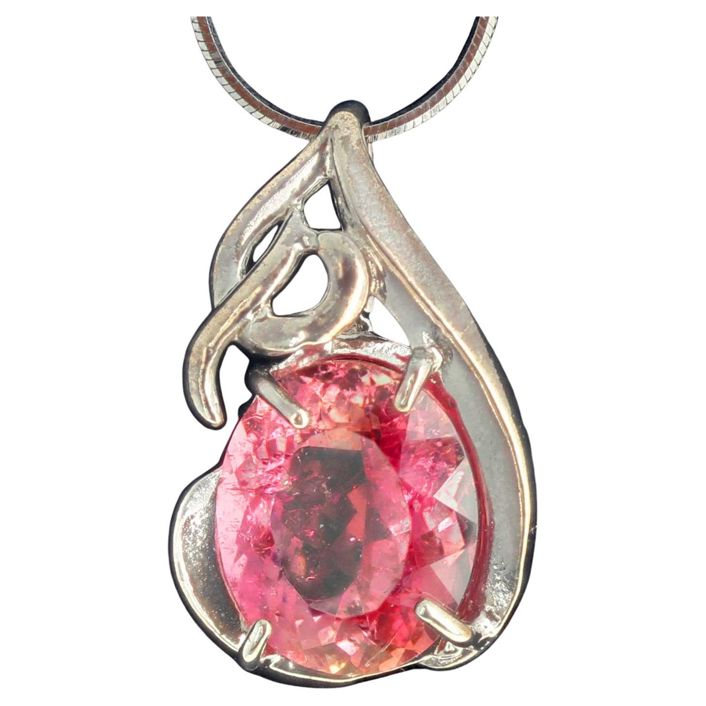 Unique Handmade glittering pink with apricot glitters around the edges 7 carat Tourmaline set in a lovely Sterling Silver pendant that hangs approximately .78 inches long. 