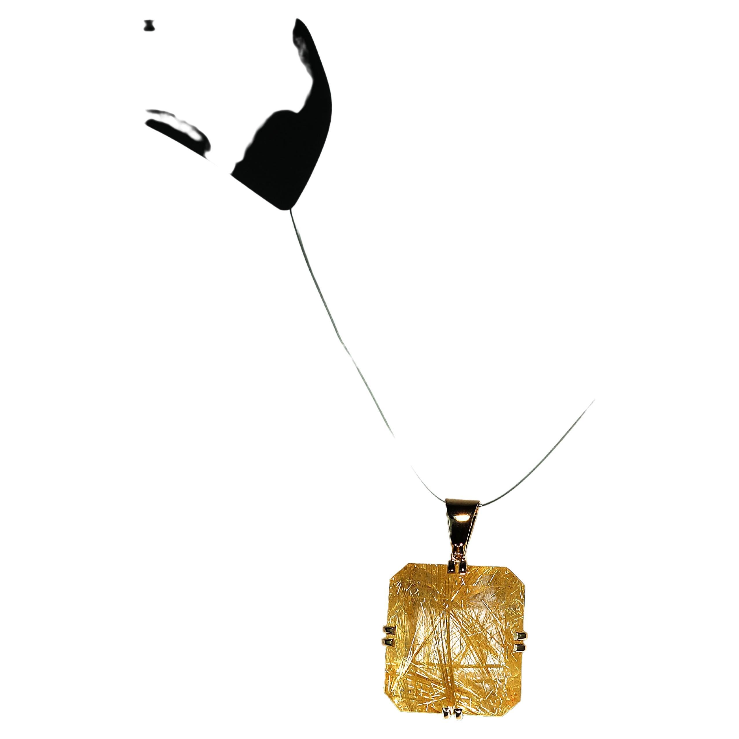 101.79 Carats of incredible golden Rutilated Quartz set in hand crafted 14KT yellow gold pendant. This is a must have for all you collectors. This unique gemstone is emerald cut and measures approximately 28x27 MM. The Rutile is absolutely beautiful