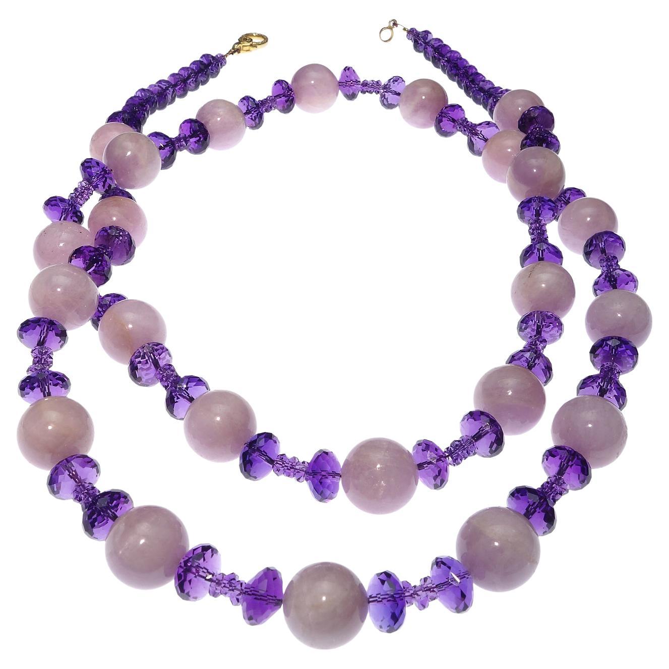 Handmade necklace of Sparkling Amethyst rondelles and glowing spheres of Kunzite.  This unique 35 inch long necklace commands your attention.  Wear it long or wrap it once.  The two sizes of glittering faceted Amethysts dance in the light and play