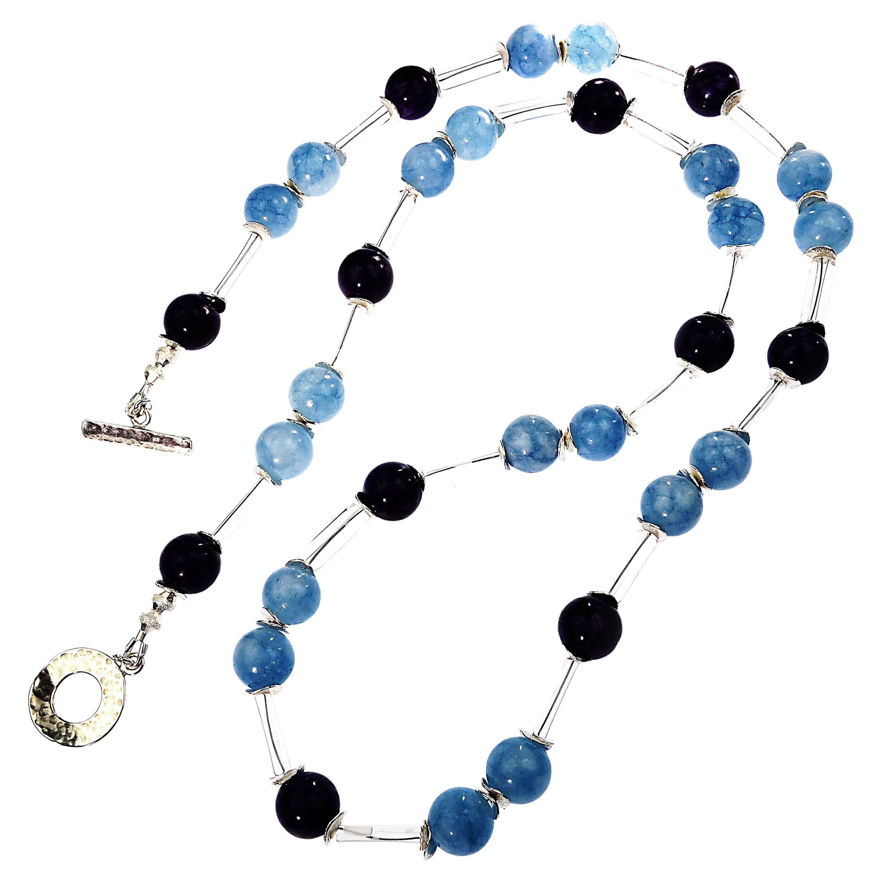 Delightful, unique, lightweight necklace featuring Aquamarine and Charoite spaced by clear crystal tubes. The lovely blue Aquamarine is accented with silver tone flutters, as is the glowing purple Charoite.  Wear this fun, fanciful necklace with all