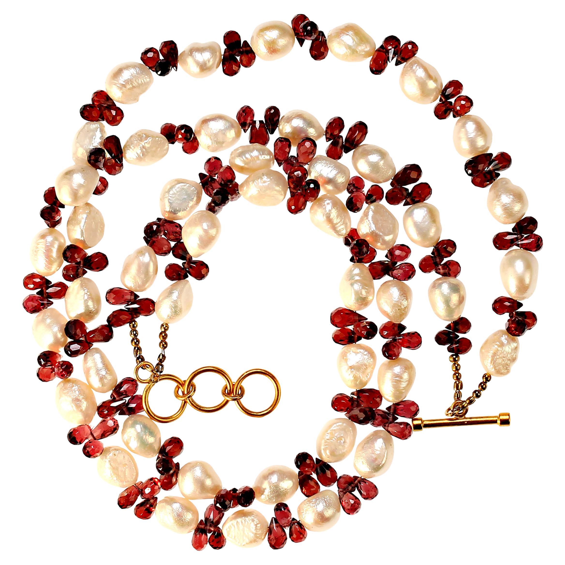 The Pearl is the Queen of Gems and the gem of Queens

Handmade rhodolite garnet briolettes are combined with glowing white freshwater pearls to create this sophisticated and elegant necklace. The glowing garnets are grouped in threes to emphasize