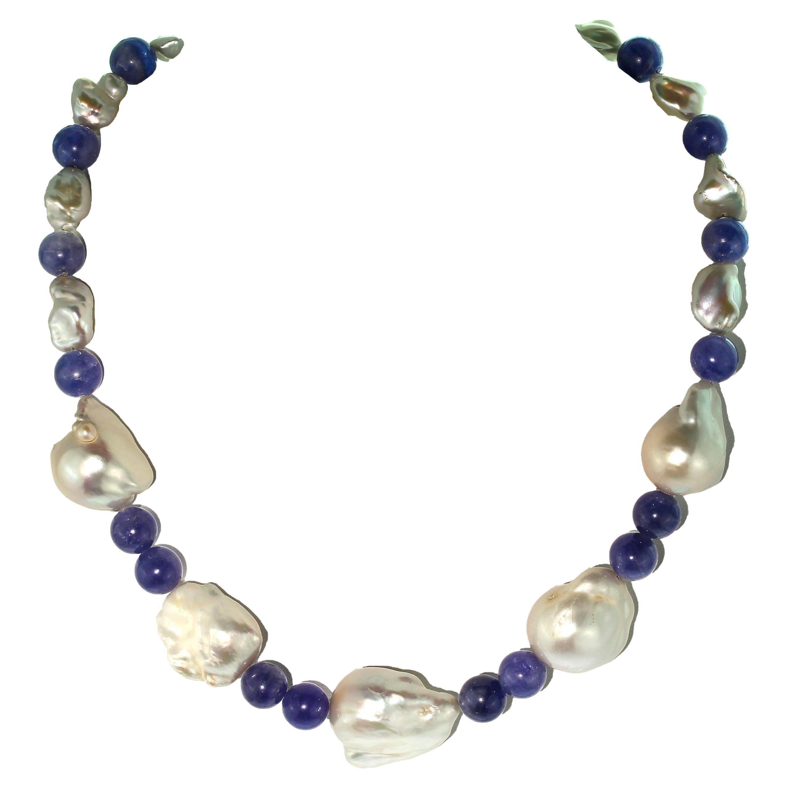 Keep Calm and Wear Pearls

One of a kind necklace featuring iridescent white Baroque Pearls, white Keshi Pearls, and round 10 MM highly polished Tanzanite. The gorgeous iridescent Baroque Pearls play off of the highly polished blue/purple Tanzanite