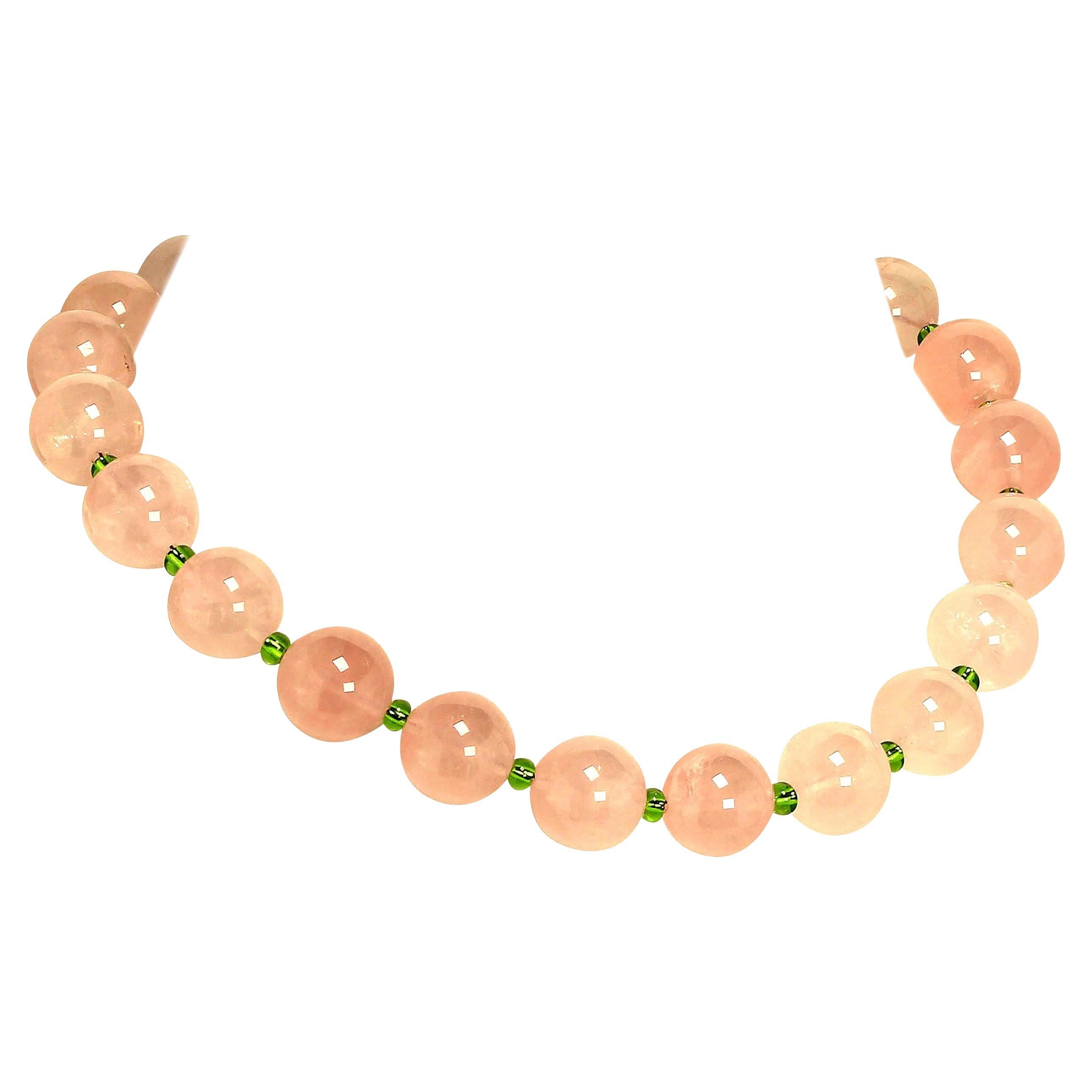 Elegant, handmade Rose Quartz and Czech bead necklace. This unique necklace features 16 MM translucent Rose Quartz accented with 3 MM sparkling brilliant green Czech beads. A hammered Sterling Silver hook and eye clasp secures this gorgeous 16 inch