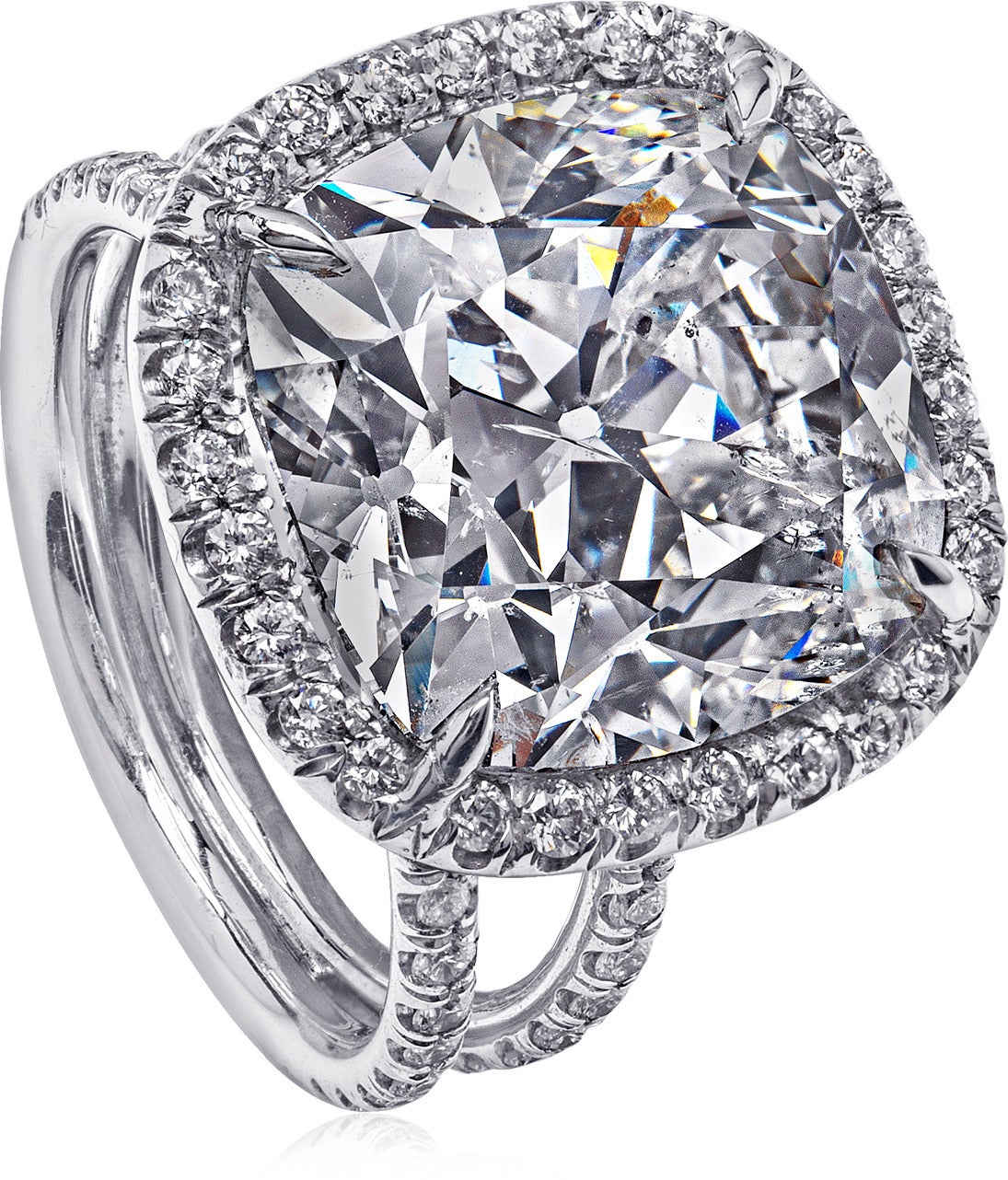 This diamond ring was made to look large.  Over 8 carat center cushion, set with a halo around to make the circumference even larger.  The center diamonds details are J color, I1 clarity.