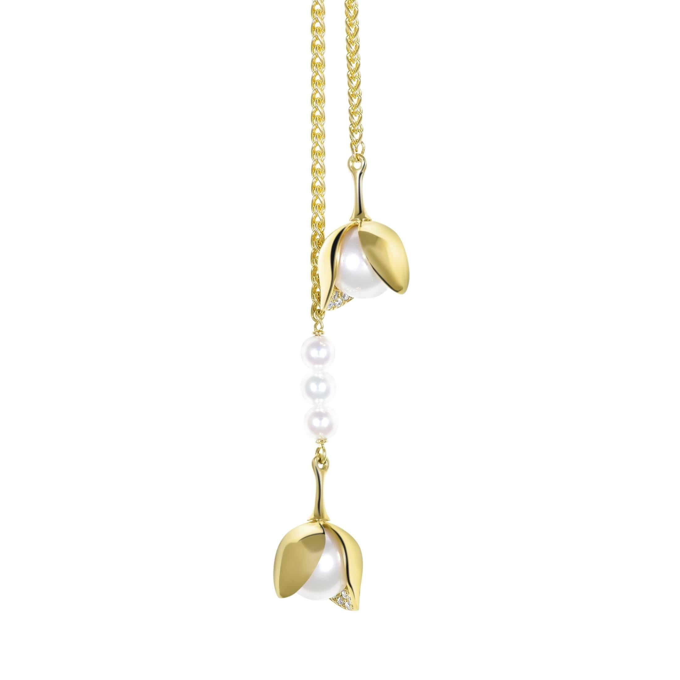 The Orchid Diamond Double Drop Necklace is embellished with three cultured Akoya pearls (3 mm) suspended from one of the two dangling cultured Akoya pearls (8 mm), each with pavé-set diamonds (0.04 tct). 80 cm in 18k Fairtrade gold. 