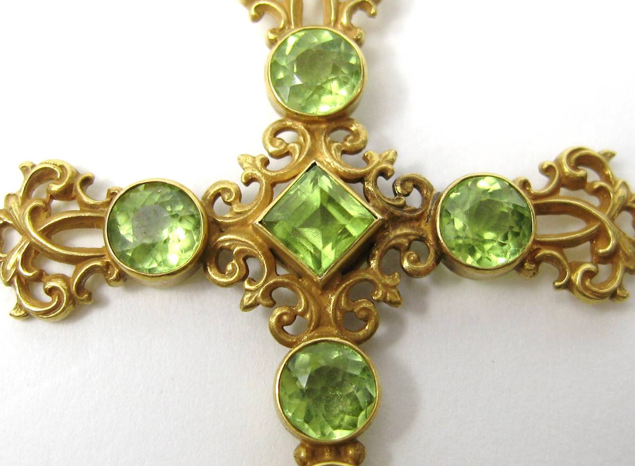 Large scale 14K gold Crucifix with bezel set Peridot stones
7 in total 
Lovely scroll design 
Measures 
2.27