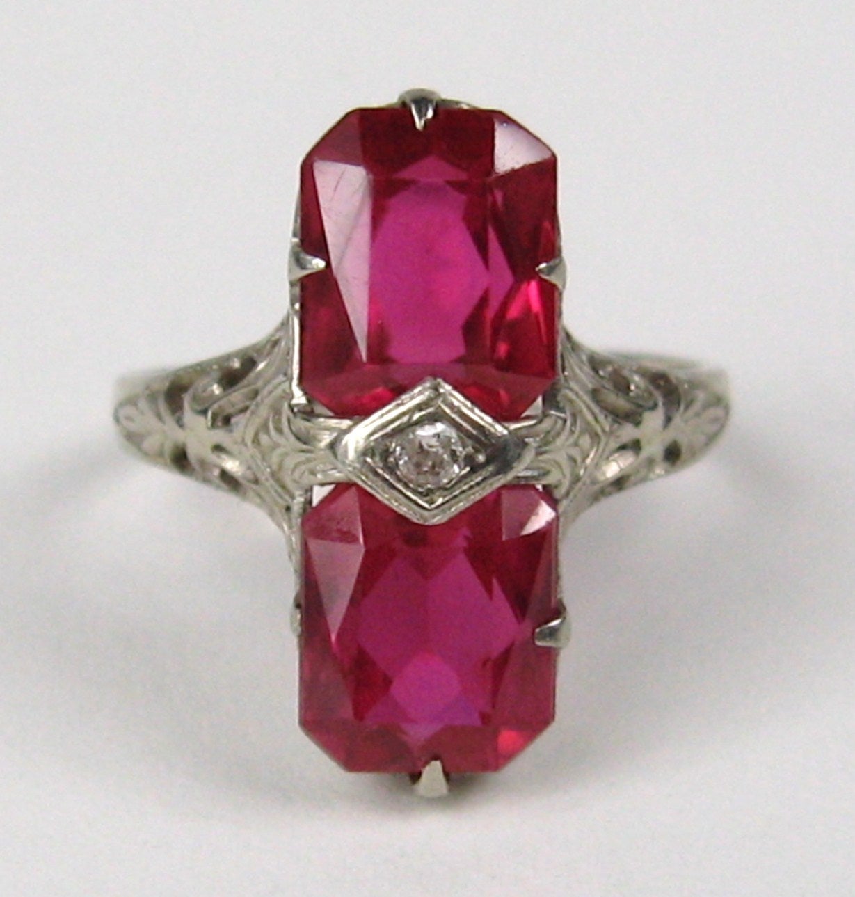 Stunning cut work on this 1920s Ring set in 14K Gold.
Spinel, most likely simulated.

Ring has a petite diamond in the center.
Ring is a size 6 and can be sized by us or your jeweler

Any questions please call or hit Request more information.