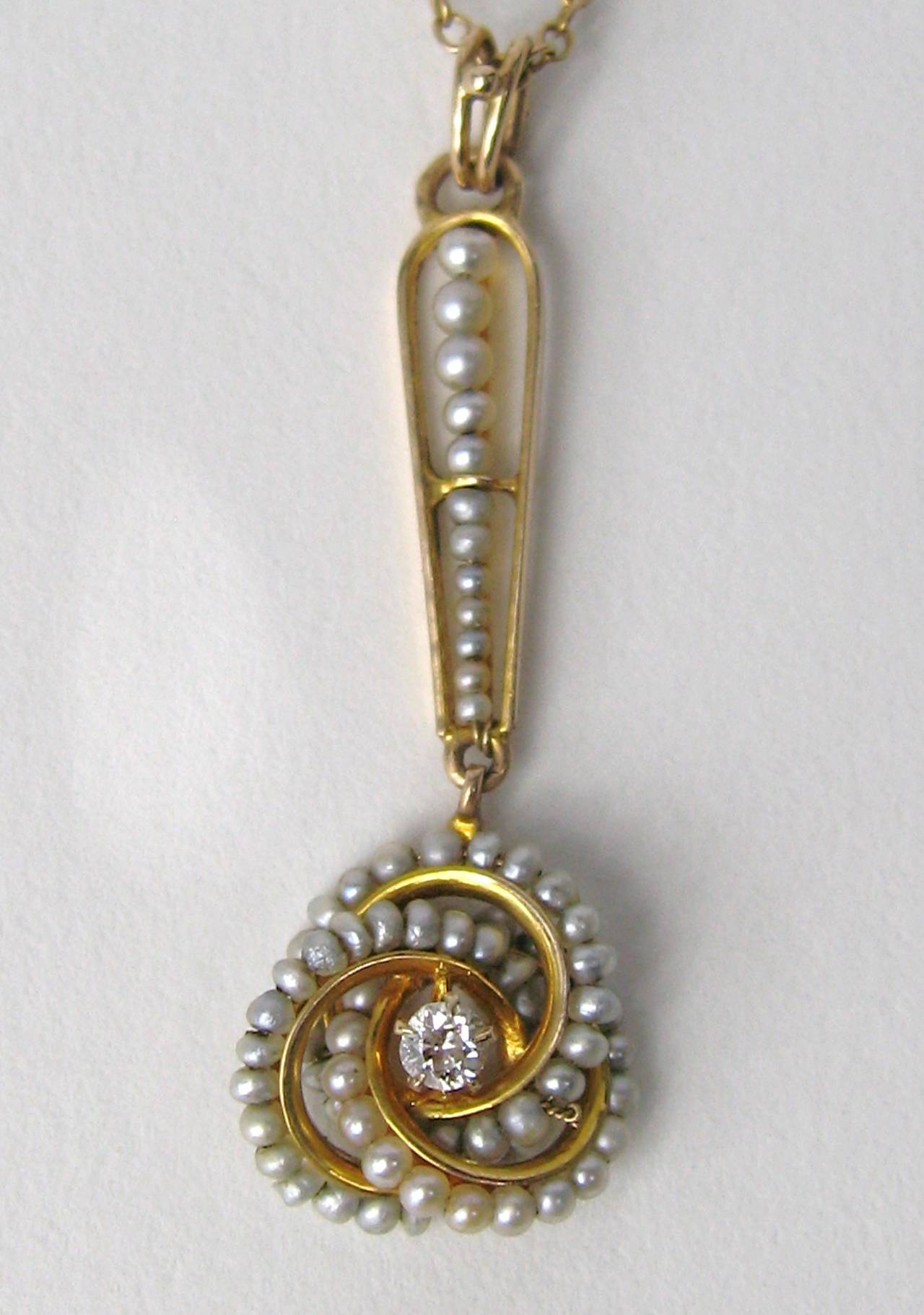 Exquiste Petite 14K Gold Lavaliere. This is a wonderful example of the 1920s.
Tiny seed pearls make up the Top and the knot with a center diamond accent.
Measures 
1.40