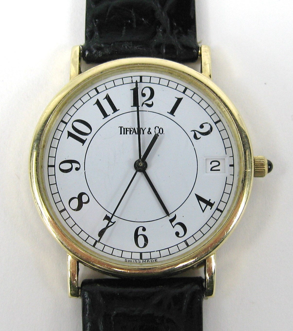 Round face Tiffany & Co. 14k Gold Watch

Sapphire Cabochon stem 
Leather band

Any questions please call or hit 