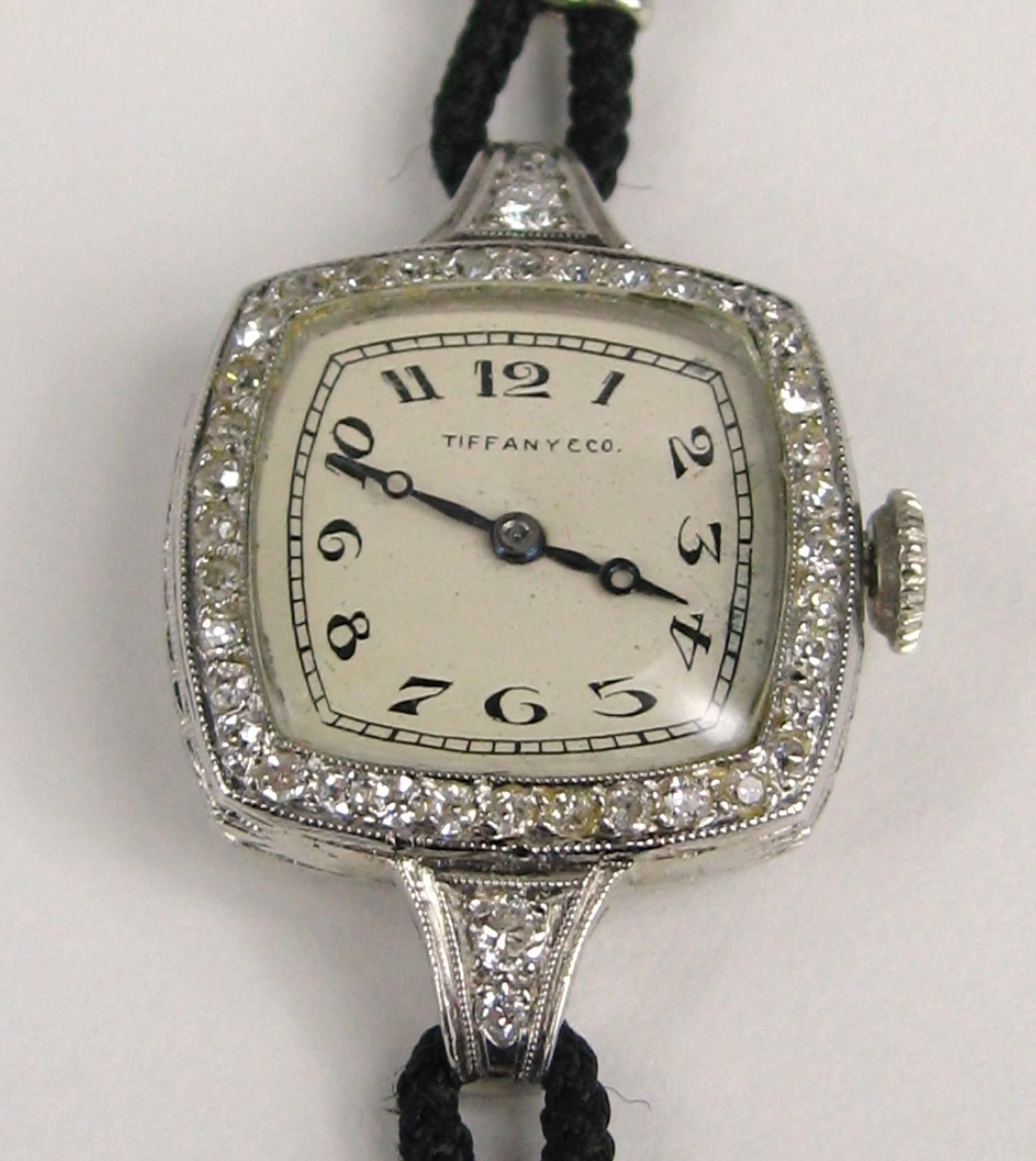 Stunning Platinum Tiffany watch Audemars, Pigute & Co
Face surrounded by Bezel set small diamonds 
Black cloth band
14K white Gold end caps 
Watch is working 
Measuring 
1.17