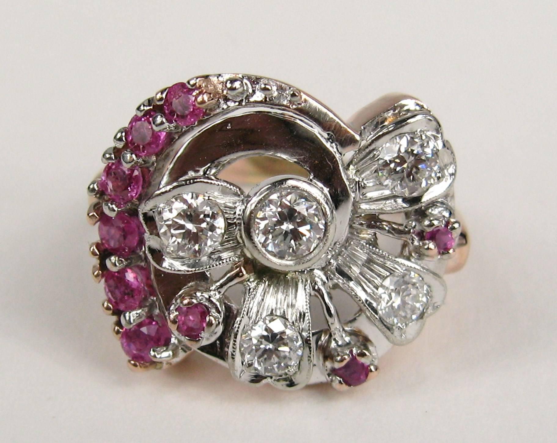 14k Rose and White Gold Ruby and Diamond Cocktail Ring. Center round brilliant bezel set diamond approximately .30 carats, surrounded my 4 smaller round brilliant cut diamonds approximately .72 carats, G/H color SI clarity and 9 prong set rubies