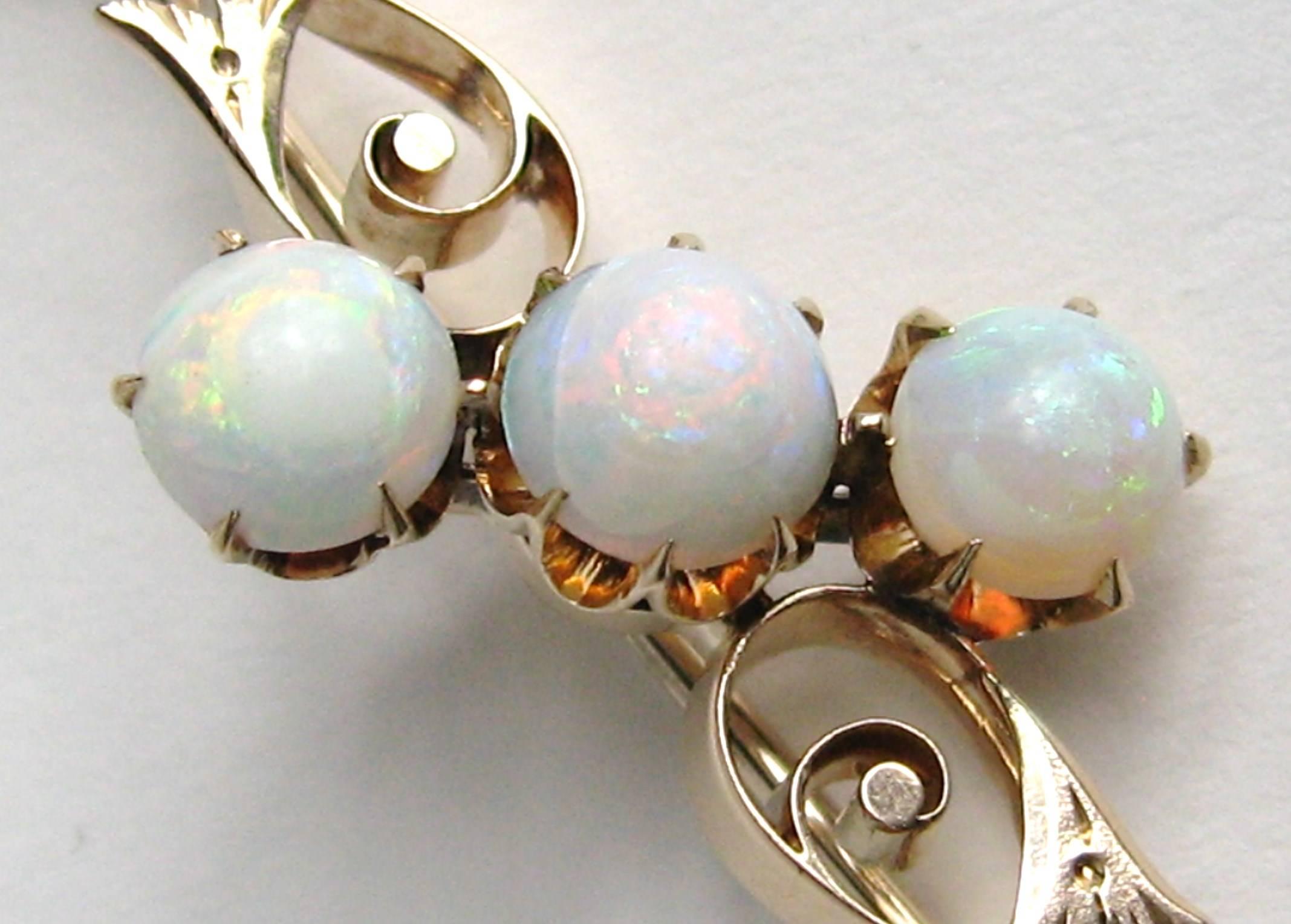 Stunning 10K Rose Gold 3 Opal Brooch. Measuring 1.97 inches wide x .60 top to bottom measuring opals.  Opals are claw set, 3 in total. Early C-style closure. This is out of a massive collection of Contemporary designer clothing as well as Hopi,