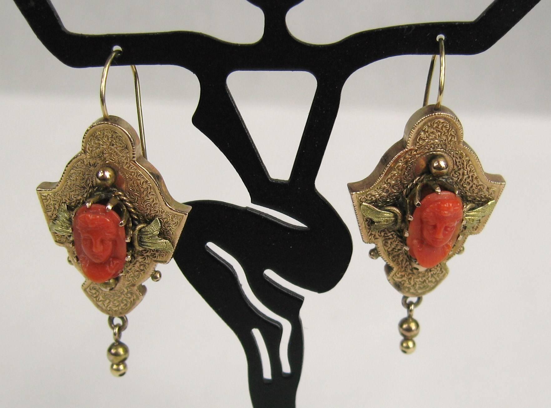 This is TRULY a Stunning pair of antique 14K Gold Yellow and Green Gold CORAL cameo Earrings. These are elaborate, with what looks to be a man on one earring and a woman on the other, great detailing in the coral carving. measuring 1.64 inches or