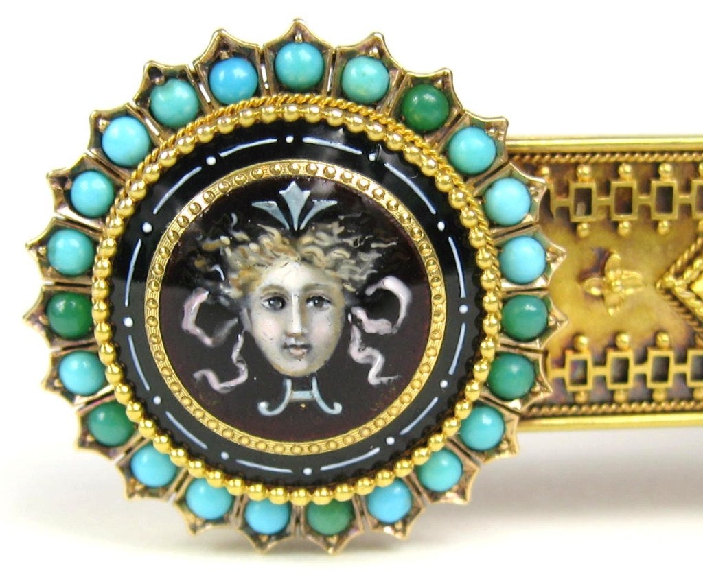 Stunning Gold Victorian Bar Pin with wonderful hand-painted porcelain Mythical Depictions on each end. They are surrounded by Turquoise.  
During the second half of the 19th century, Victorian jewelers often turned to mythological themes, Victorian