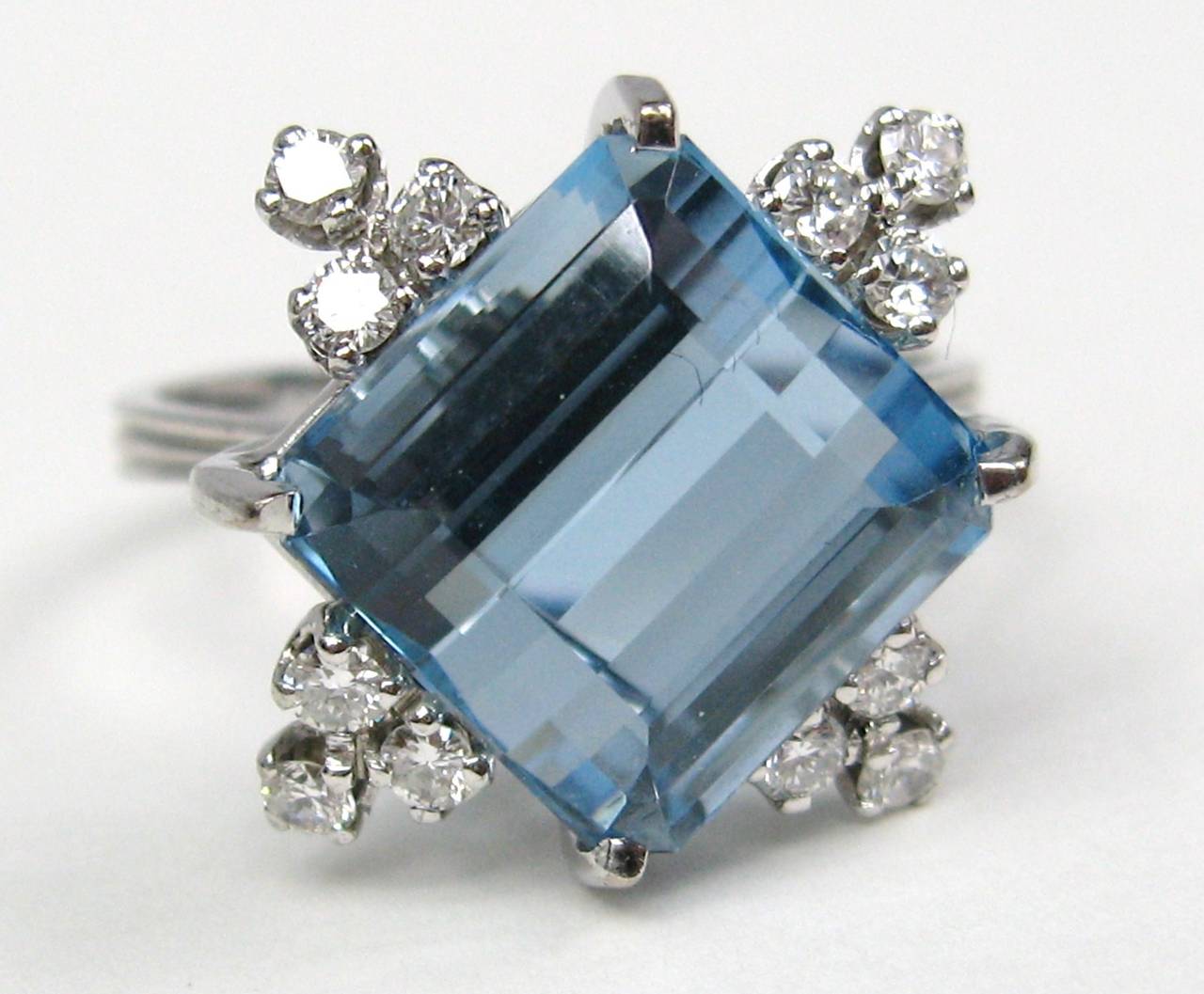 Stunning GIA Certified 18K White Gold Ring with center 7.20 Carat Aquamarine Stone. Square Asscher cut, Surrounded by 12 Diamonds Approximately 1/2 Carat, 3 on each angle. Ring is a size 8-3/4 and can be sized by us or your jeweler. GIA Certified #